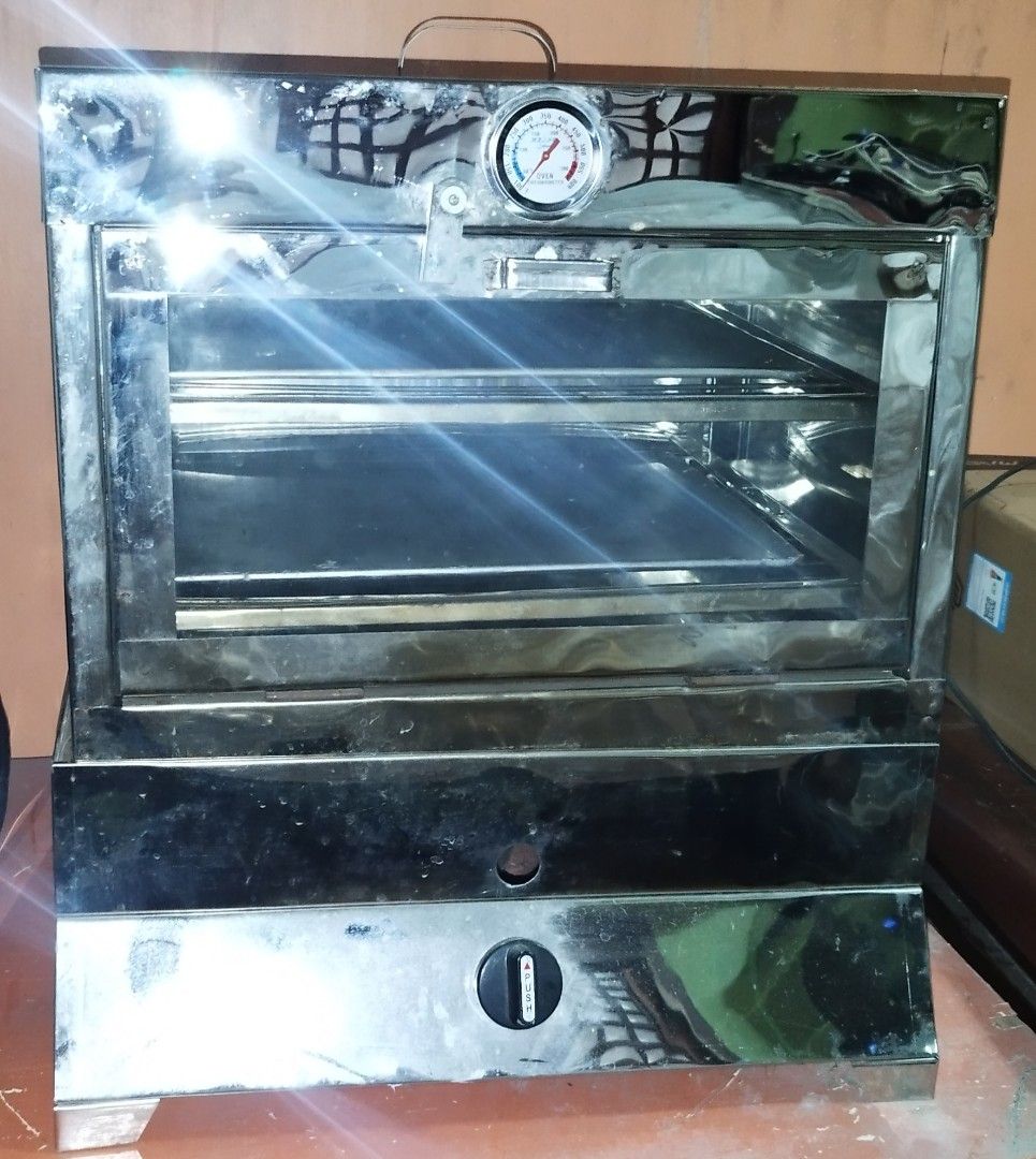 Stainless Steel Oven with Thermometer (Category: Ovens & Toasters) located in Manila. Submitted by edgarcabral (Listing ID 1419049459, Image 2). Description: - Stainless steel oven - Built-in thermometer - Top handle - Bottom control knob - Includes two internal racks - Approximately 20" wide and 20" tall - In good working condition.