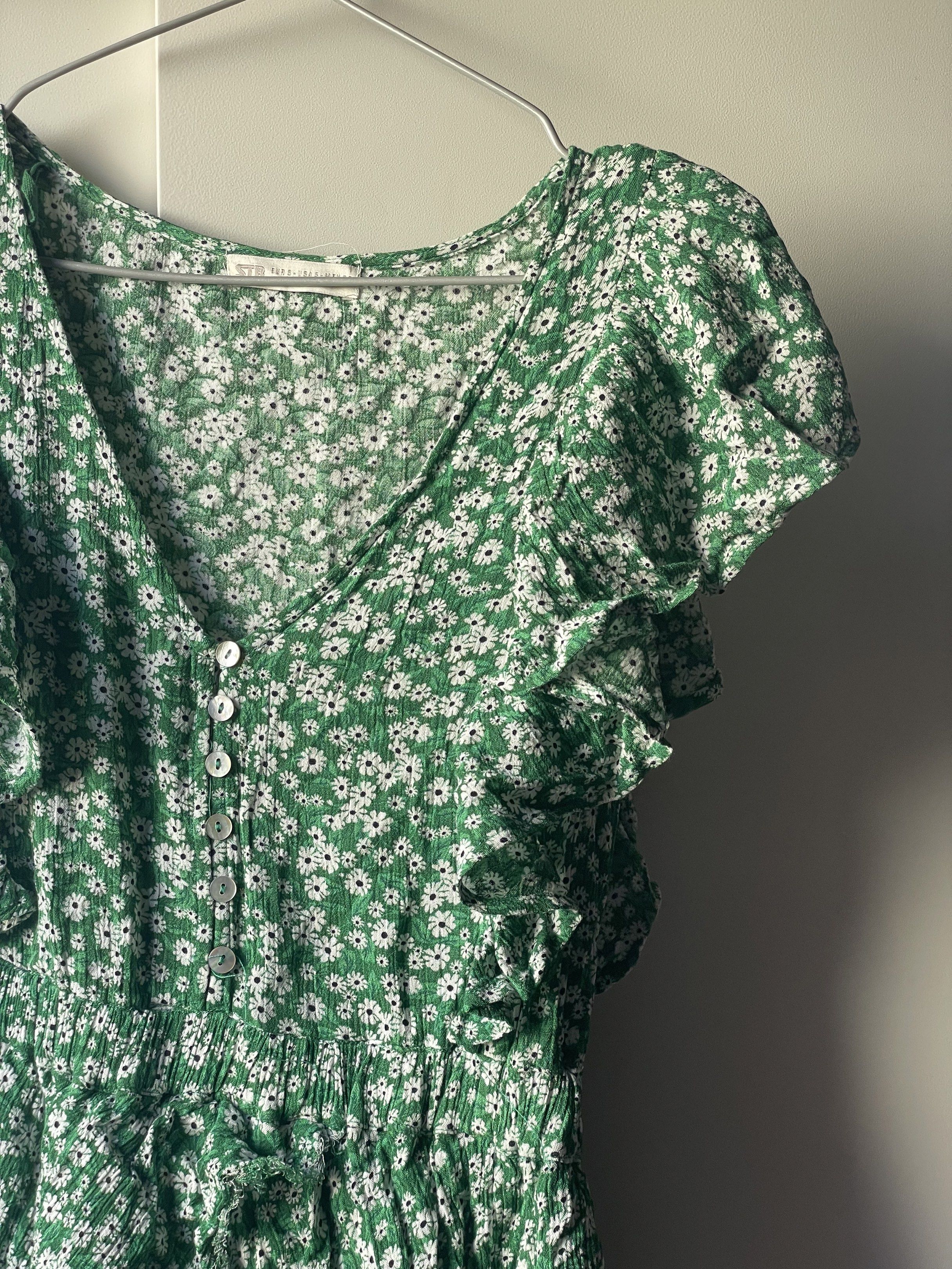 STR Floral Mini Dress (Category: Dresses) located in Manila. Submitted by chenpots (Listing ID 1419058598, Image 3). Description: - Brand: STR - Size: S - Style: Mini dress - Features: - Green with floral pattern - V-neck - Ruffled sleeves - Button-down front - Gathered waist - Tiered skirt.