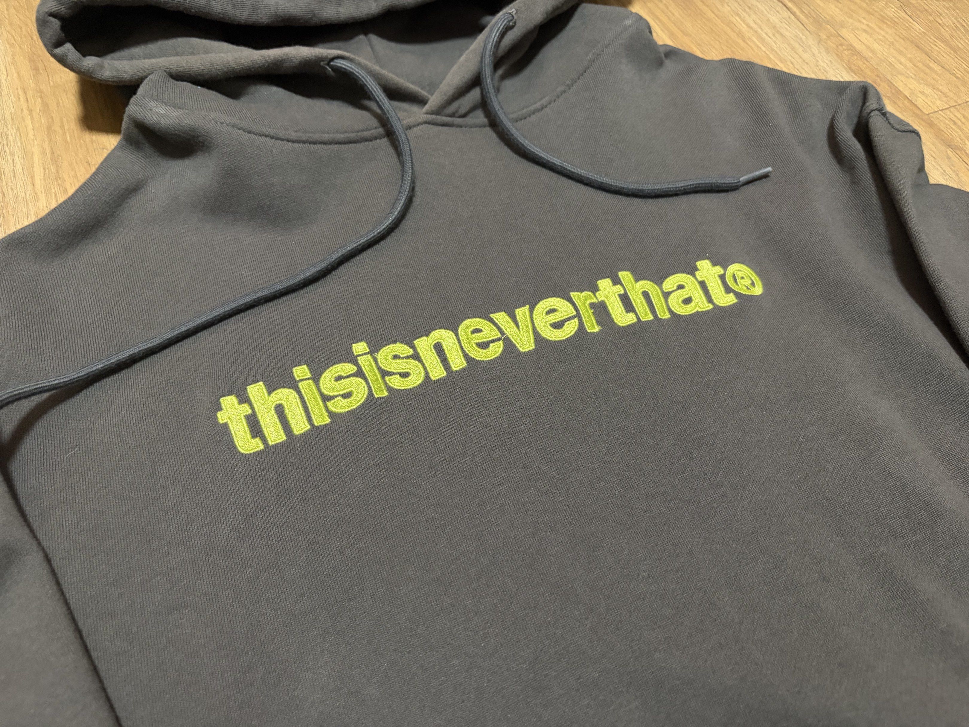 thisisneverthat Hoodie (Category: Hoodies) located in Pasig City. Submitted by getbands445 (Listing ID 1419036933, Image 2). Description: - thisisneverthat hoodie - Dark gray color - Neon green logo on front - Size: S - Features: Hood with drawstrings, kangaroo pocket - Made in Korea.