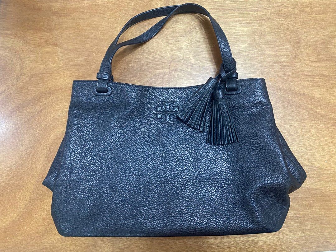 Tory Burch Black Leather Handbag (Category: Luxury Bags & Wallets) located in Manila. Submitted by onebrickatatime (Listing ID 1419030610, Image 1). Description: - 100% authentic - Clean inside & out - No flaws/issues - Tory Burch Thea black pebble leather tote bag with tassels - Top handle design - Stylish tassel detail - Gold-toned zipper - Multiple interior compartments - Branded label inside - Textured leather exterior RFS: Decluttering ***Ne