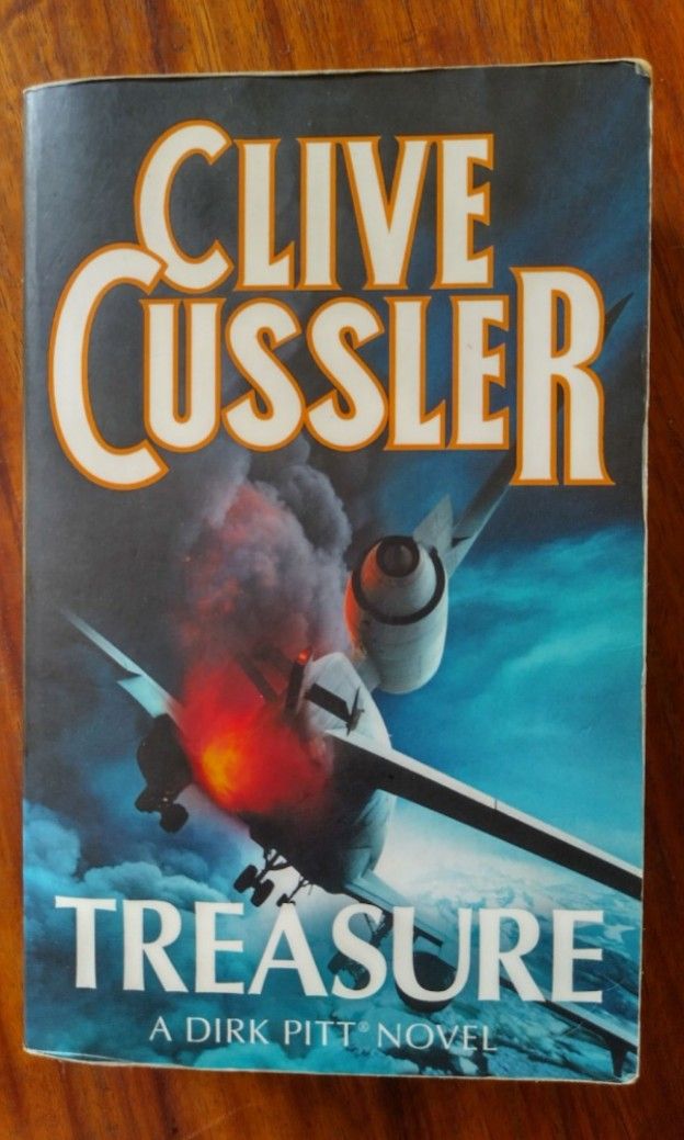 Treasure by Clive Cussler: A Dirk Pitt Novel (Category: Storybooks) located in Paranaque City. Submitted by cgeerod (Listing ID 1419042389, Image 1). Description: Copy of "Treasure: A Dirk Pitt Novel" by Clive Cussler. The book features a thrilling story involving a search mission, a crippled Soviet submarine, and international terrorism. Published by HarperCollins. genre: action adventure thriller Pre-loved mass market paperback payment via Gcas