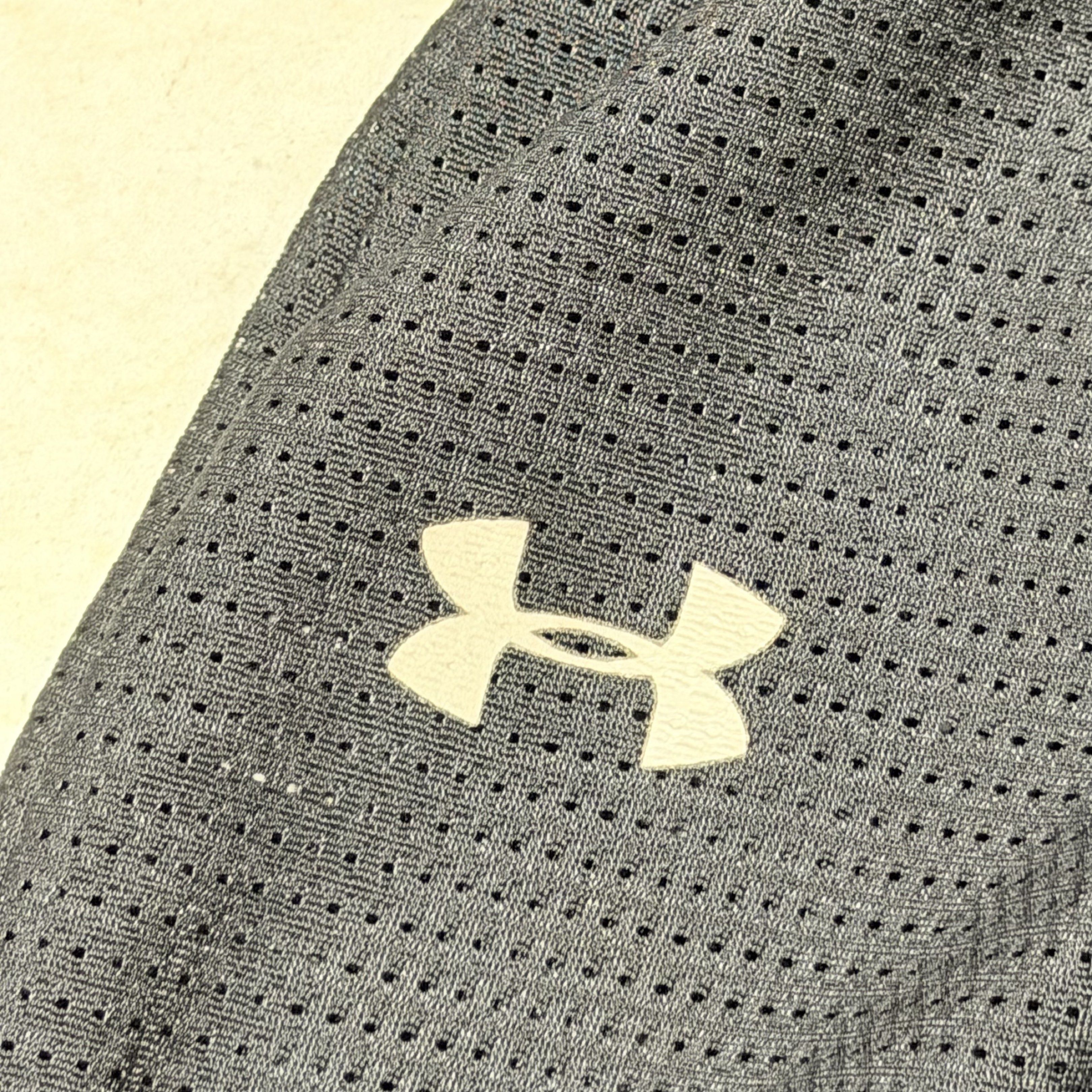 Under Armour Performance Shorts YLG (Category: Shorts) located in Pasig City. Submitted by decluttertrends (Listing ID 1418999566, Image 3). Description: - Under Armour performance shorts - Color: Black - Size: YLG - Features: - Mesh design - Built-in pouch - Padding on front - Material: 100% polyester, 19% elastane - Made in China - Under Armour logo on leg and waistband.