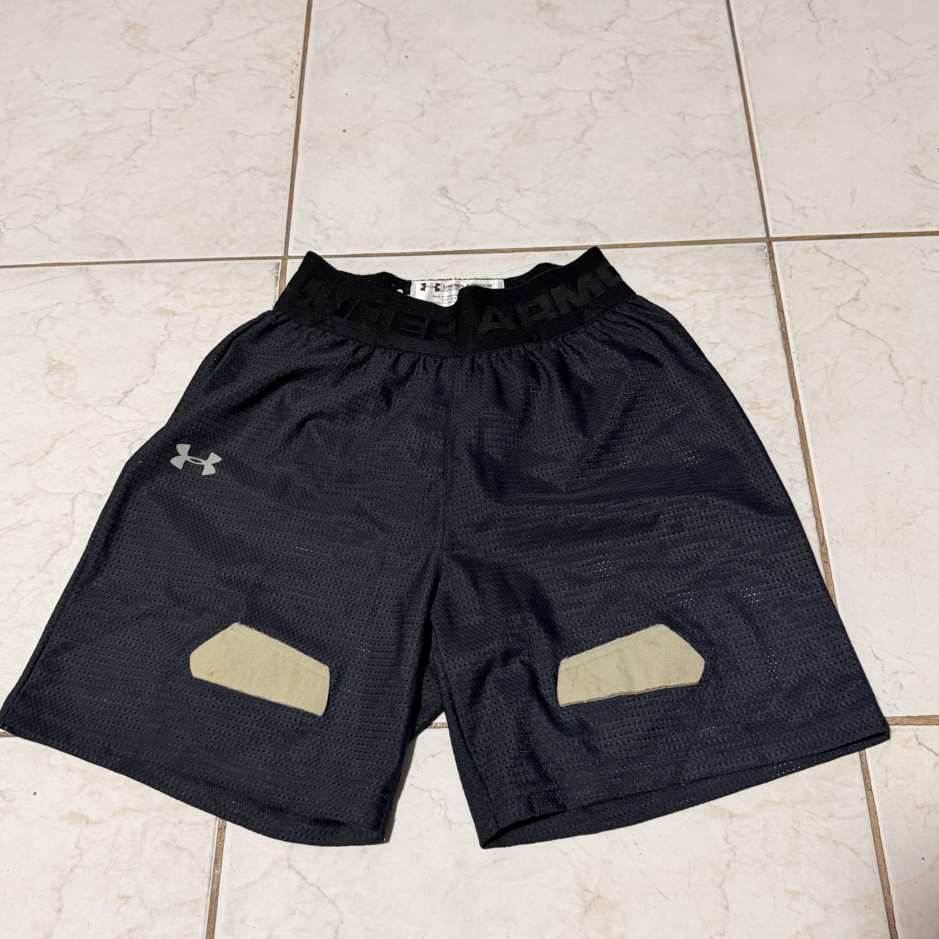 Under Armour Performance Shorts YLG (Category: Shorts) located in Pasig City. Submitted by decluttertrends (Listing ID 1418999566, Image 1). Description: - Under Armour performance shorts - Color: Black - Size: YLG - Features: - Mesh design - Built-in pouch - Padding on front - Material: 100% polyester, 19% elastane - Made in China - Under Armour logo on leg and waistband.