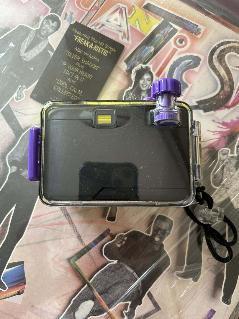 Underwater Camera (Category: Cameras) located in Manila. Submitted by loaf.breed26 (Listing ID 1419004917, Image 2). Description: - Underwater camera with a vibrant green and purple design. - Comes with a clear protective case. - Features a lens and viewfinder. - Includes a convenient wrist strap. - Designed for underwater photography..
