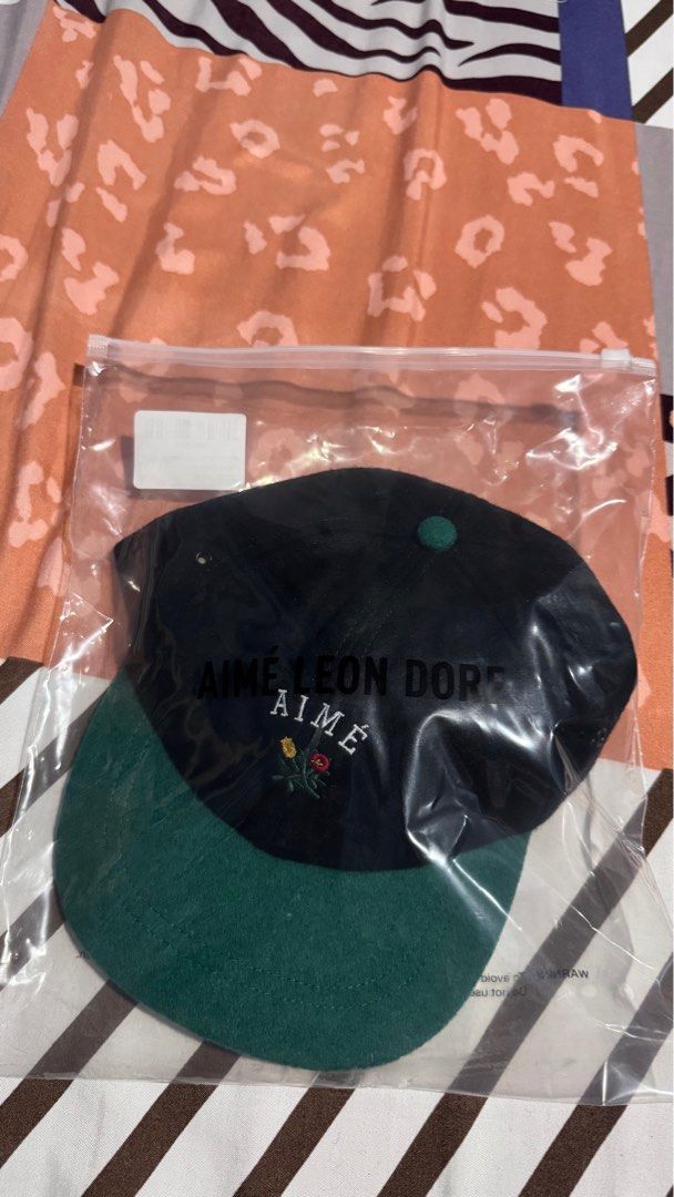 Aime Leon Dore Melton Wool Colorblock Cap (Category: Caps & Hats) located in Manila. Submitted by pauuudp (Listing ID 1420771774, Image 2). Description: - Authentic Aime Leon Dore cap bought directly from the website - Classic design: Black wool crown with a green brim (Jet Black) - Features the iconic Aime logo embroidered on the front - Size: OS (One Size) - Material: 70% polyester, 30% wool.