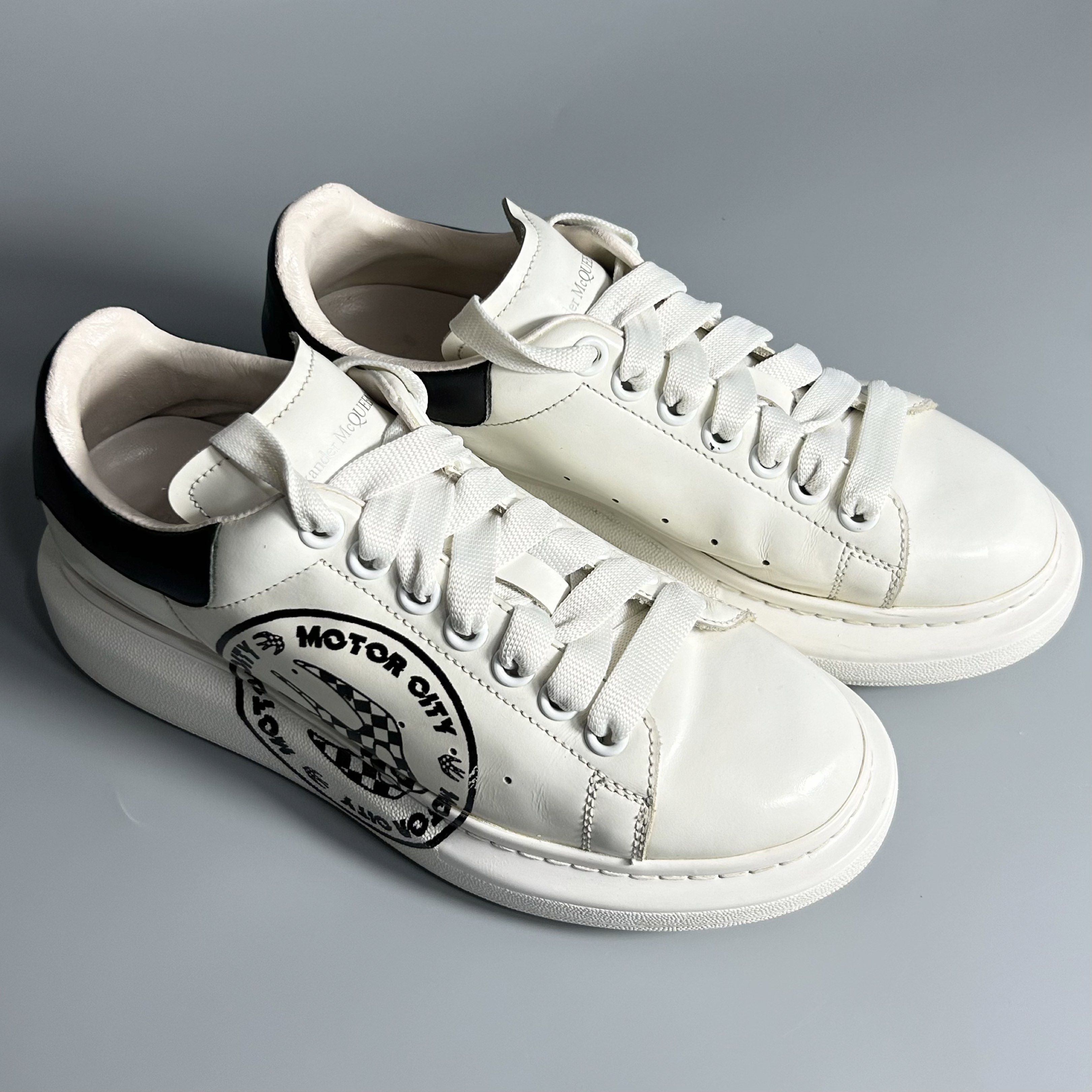 Alexander McQueen Motor City Sneakers (Category: Sneakers) located in Cavite. Submitted by datsoretro (Listing ID 1420927171, Image 1). Description: - Alexander McQueen sneakers - White with black accents - "Motor City" design - Size 38 D - Made in Italy - Some wear on soles - Alexander McQueen logo present.