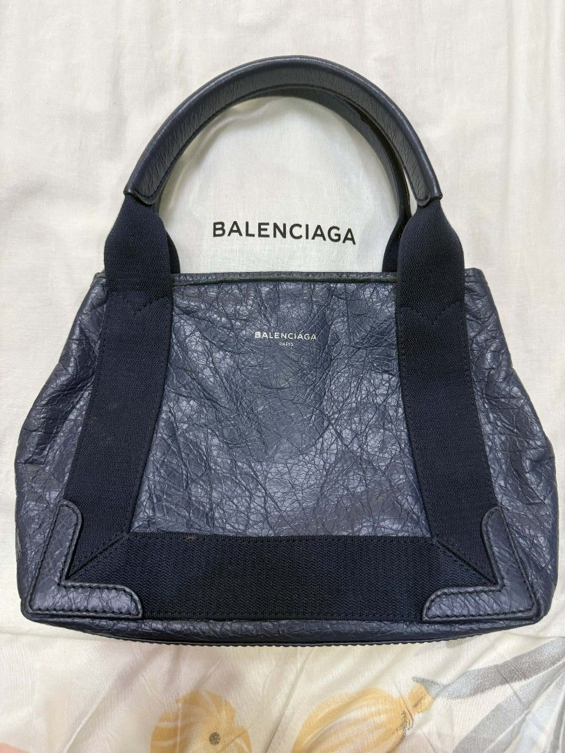 Balenciaga Navy Leather Handbag (Category: Luxury Bags & Wallets) located in Caloocan City. Submitted by fiercestone-c8e70e (Listing ID 1420788675, Image 1). Description: Authentic Balenciaga handbag in navy blue leather. Features top handle, detachable shoulder strap, and zipper closure. Includes dust bag. Made in Italy..