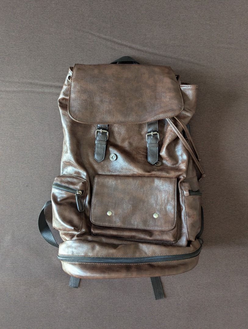 Brown Leather Backpack (Category: Backpacks) located in Manila. Submitted by quality_goods_ (Listing ID 1420831102, Image 1). Description: Faux leather rucksack backpack with multiple compartments. Approx H 50cm x W 30cm x D 18cm Chocolate brown Hardly used .