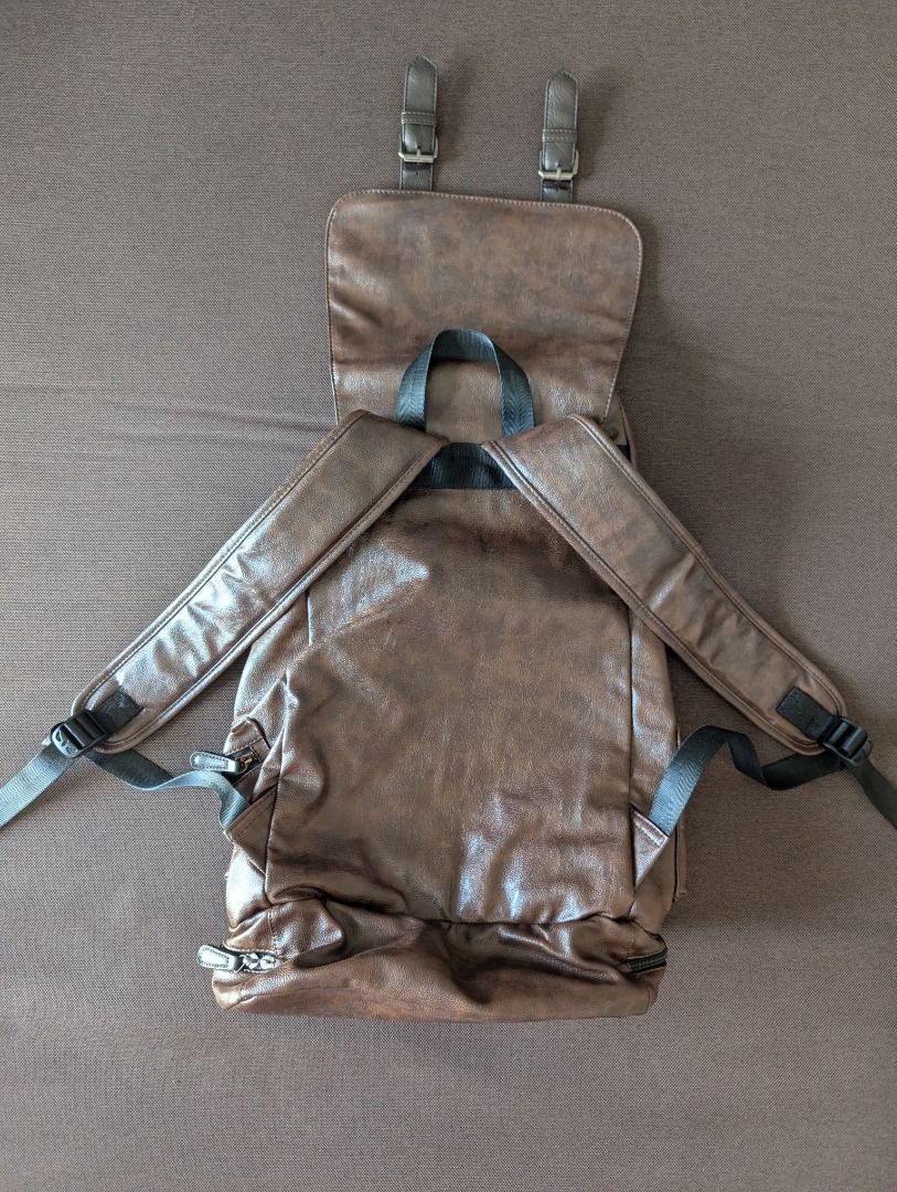 Brown Leather Backpack (Category: Backpacks) located in Manila. Submitted by quality_goods_ (Listing ID 1420831102, Image 3). Description: Faux leather rucksack backpack with multiple compartments. Approx H 50cm x W 30cm x D 18cm Chocolate brown Hardly used .