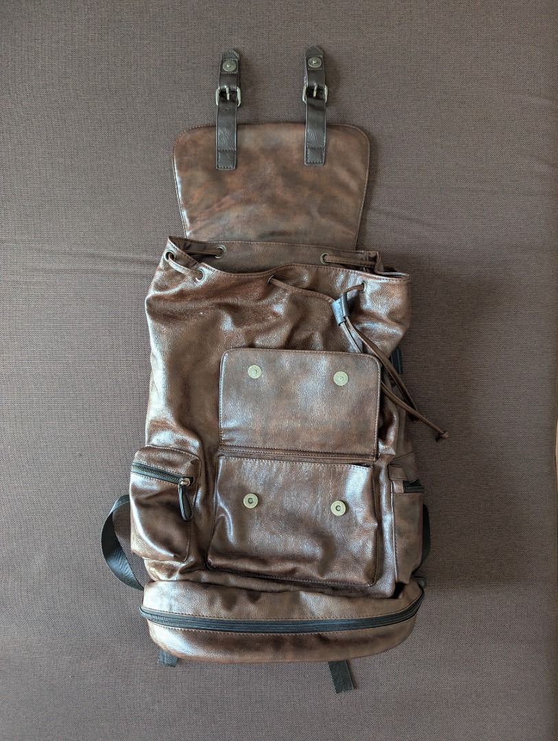 Brown Leather Backpack (Category: Backpacks) located in Manila. Submitted by quality_goods_ (Listing ID 1420831102, Image 2). Description: Faux leather rucksack backpack with multiple compartments. Approx H 50cm x W 30cm x D 18cm Chocolate brown Hardly used .