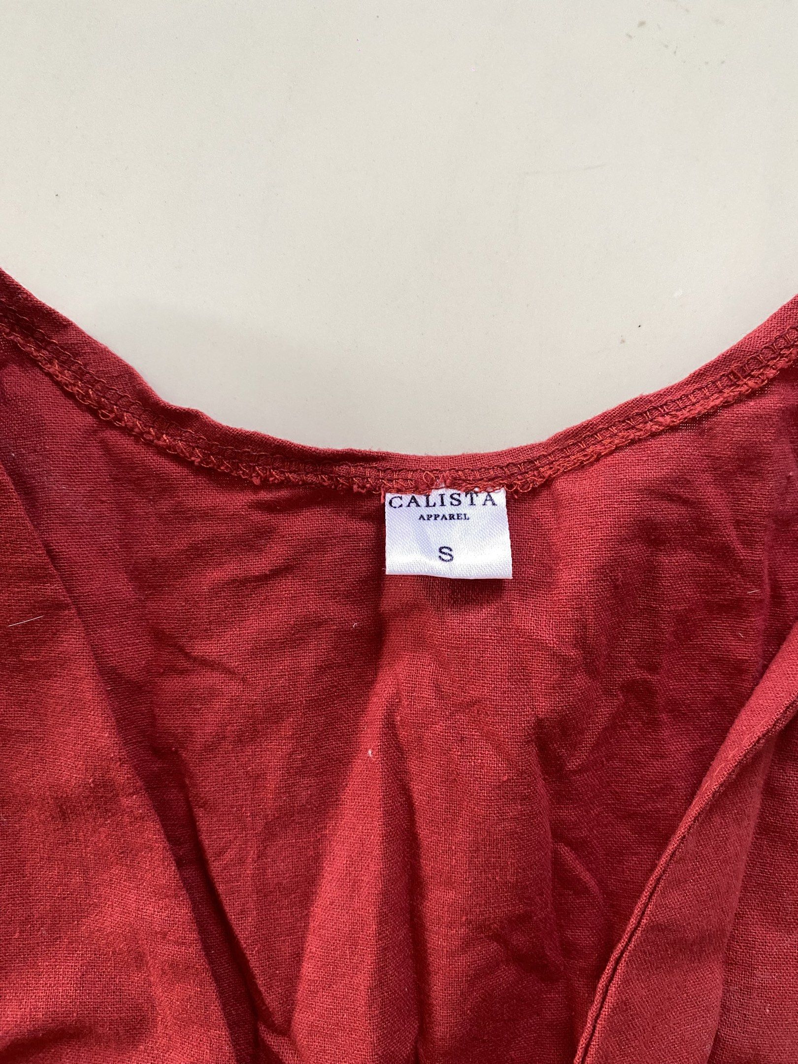 Calista Apparel Red Front-Tie Top (Category: Sleeveless) located in Valenzuela. Submitted by mikaaaami (Listing ID 1420794920, Image 3). Description: ☆ Solid red color ☆ Fits XS-S ☆ Has a very small stain at the back but washable.