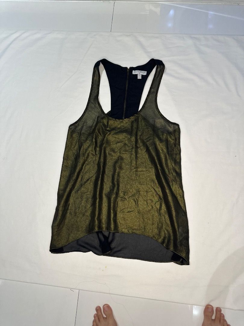 Cotton On Metallic Tank Top (Category: Sleeveless) located in Taguig. Submitted by chinkudeul (Listing ID 1420825590, Image 2). Description: - Brand: Cotton On - Size: S - Design: Metallic gold front, black back - Style: Racerback - Features: Zipper detail - Construction: Layered design with black lining Cotton On Black Gold Sleeveless Top Brand: Cotton On Size: S Condition: Lightly Used Issue (if any): No Issues Price: 150 RFS: Decluttering.