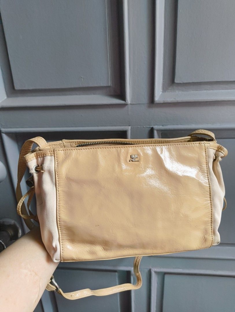Courreges Shoulder Bag (Category: Luxury Bags & Wallets) located in Caloocan City. Submitted by makyojs (Listing ID 1420870945, Image 3). Description: - Courreges shoulder bag in beige - Zip closure - Adjustable strap - Multiple interior compartments - Rectangular shape - Light beige color with contrasting beige side panel - Courreges logo on front and inside.