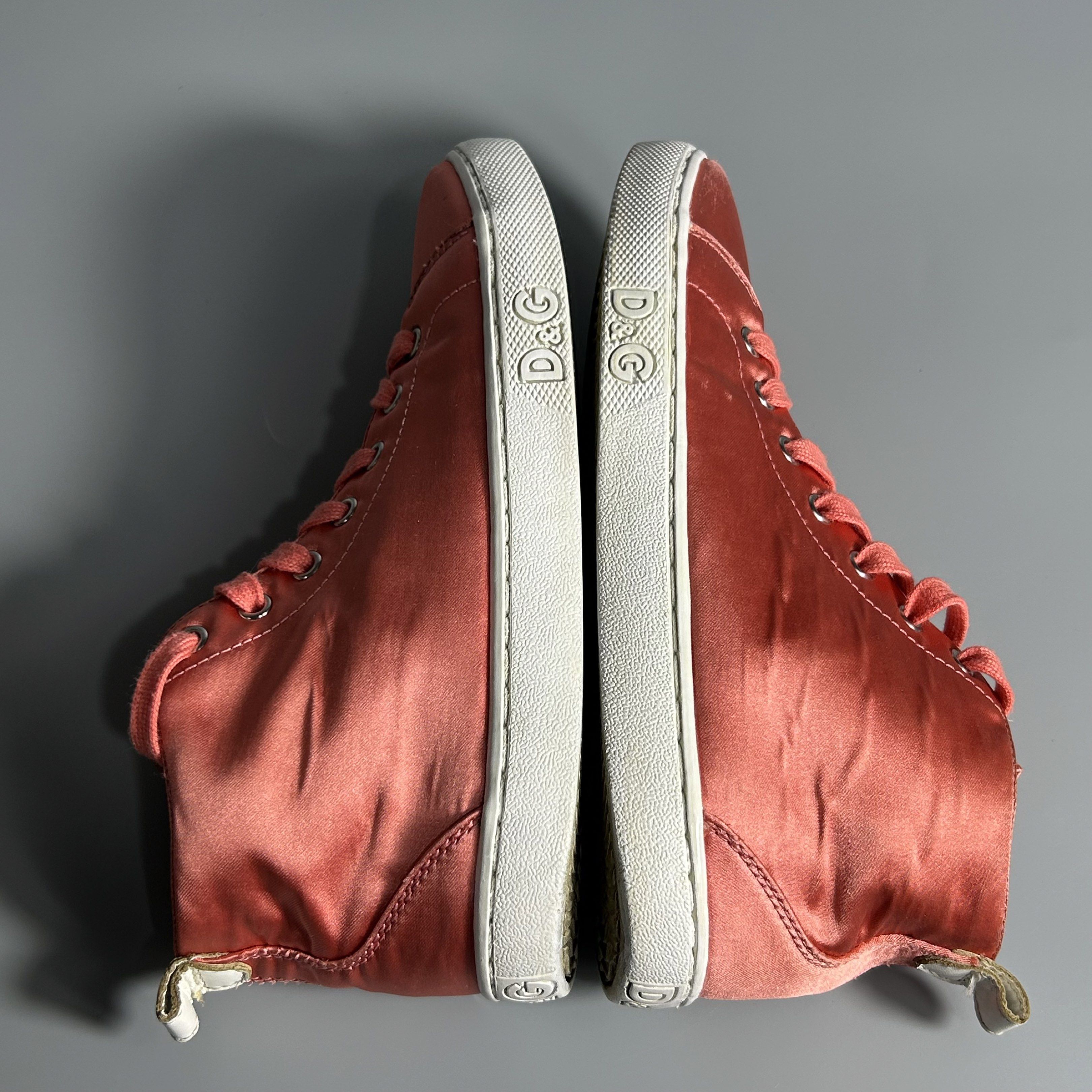 D&G Pink Satin High-Top Sneakers (Category: Sneakers) located in Cavite. Submitted by datsoretro (Listing ID 1420927740, Image 2). Description: - D&G high-top sneakers - Peach satin upper - White soles with D&G logo - Matching peach laces - White leather detail on the back - D&G logo on the interior - Size 35 - Visible bubbles/creases due to use.