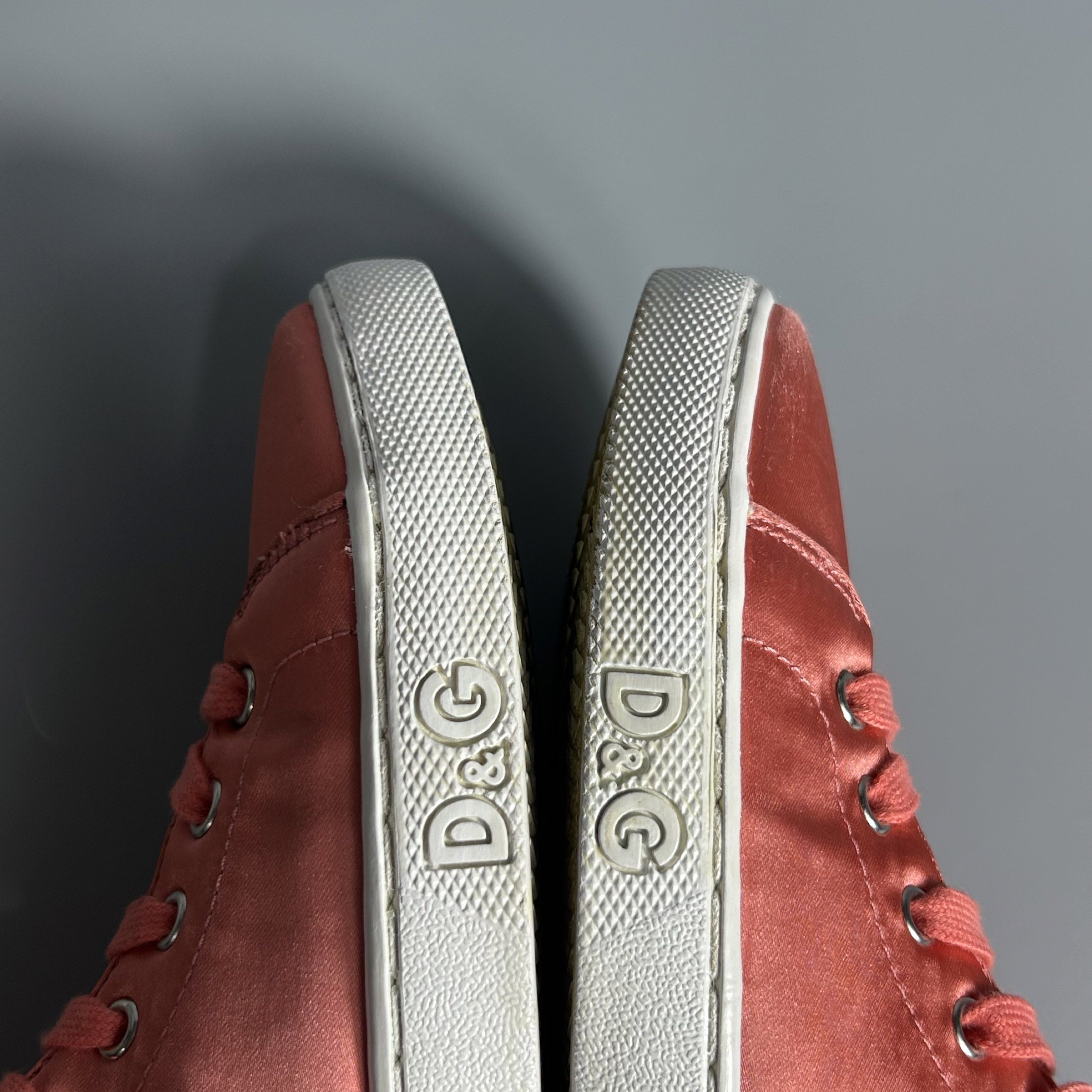 D&G Pink Satin High-Top Sneakers (Category: Sneakers) located in Cavite. Submitted by datsoretro (Listing ID 1420927740, Image 3). Description: - D&G high-top sneakers - Peach satin upper - White soles with D&G logo - Matching peach laces - White leather detail on the back - D&G logo on the interior - Size 35 - Visible bubbles/creases due to use.
