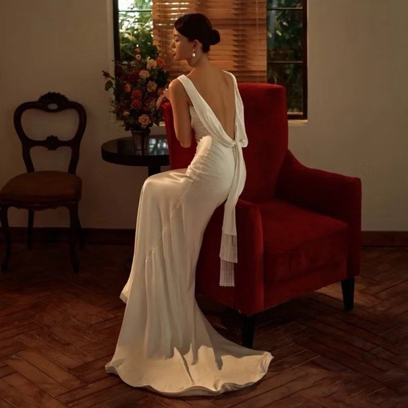 Elegant White Wedding Dress (Category: Evening dresses & gowns) located in Makati City. Submitted by _sshobe (Listing ID 1420765336, Image 1). Description: XXXL 38 inches bust 31 inches waist - Stunning white wedding dress - Draped cowl neckline - Flowing silhouette - Low back design - Delicate tie detail - Beaded accents - Subtle train - Ideal for weddings and special occasions.