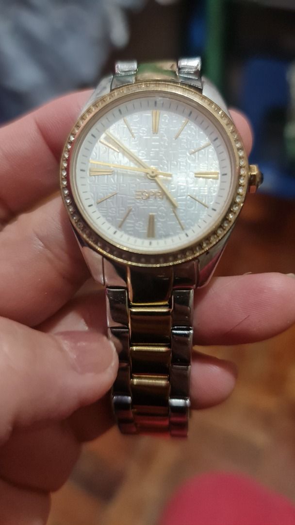 Esprit Stainless Steel Watch (Category: Women's Watches) located in Antipolo. Submitted by francesca2005 (Listing ID 1420835386, Image 2). Description: Esprit watch features a stainless steel band with gold accents. The watch face has a gold-colored bezel and a white dial. The back of the watch indicates it is water-resistant. The clasp is a fold-over style..