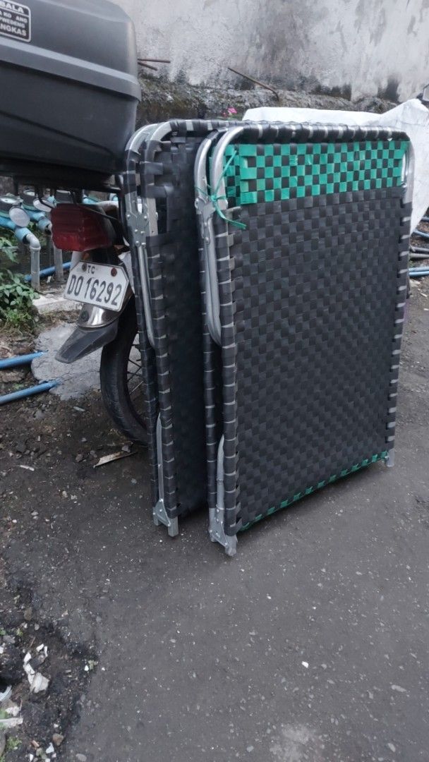 Folding Bed with Woven Surface (Category: Bed Frames & Mattresses) located in Quezon City. Submitted by michaelangelomendoza0209 (Listing ID 1420933593, Image 3). Description: Refurbished 980 plus lalamove delivery - Folding bed with woven black surface - Sturdy metal frame - Folds for easy storage and transport - Compact design - Perfect for guests or outdoor use.