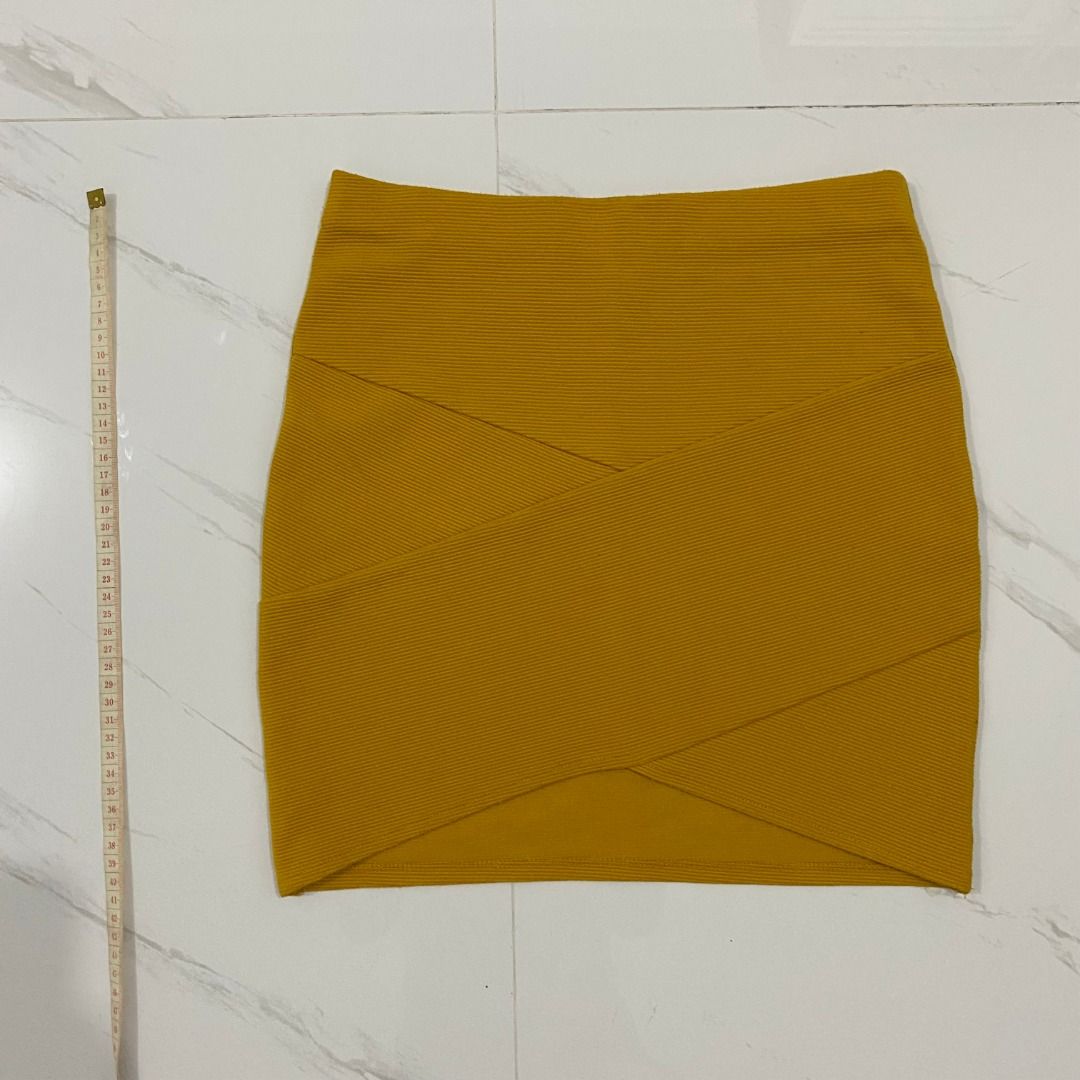 Forever 21 Mustard Yellow Mini Skirt (Category: Skirts) located in San Fernando. Submitted by deku_off (Listing ID 1420892435, Image 1). Description: Mustard yellow mini skirt from Forever 21. Features a ribbed texture and a unique criss-cross design at the front. The skirt is a size S. Made in Cambodia. A versatile piece that can be dressed up or down. Perfect for adding a pop of color to your wardrobe..