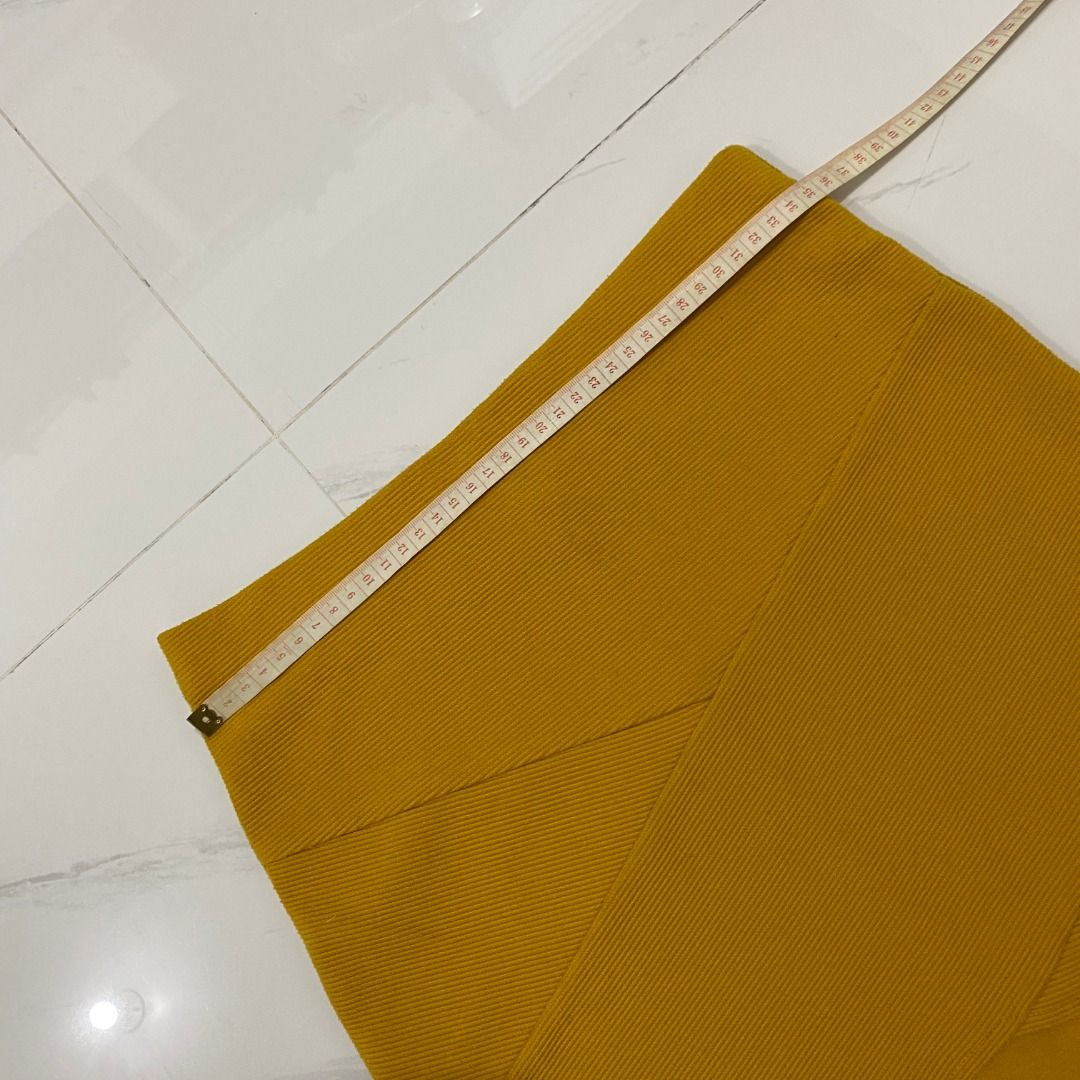Forever 21 Mustard Yellow Mini Skirt (Category: Skirts) located in San Fernando. Submitted by deku_off (Listing ID 1420892435, Image 2). Description: Mustard yellow mini skirt from Forever 21. Features a ribbed texture and a unique criss-cross design at the front. The skirt is a size S. Made in Cambodia. A versatile piece that can be dressed up or down. Perfect for adding a pop of color to your wardrobe..