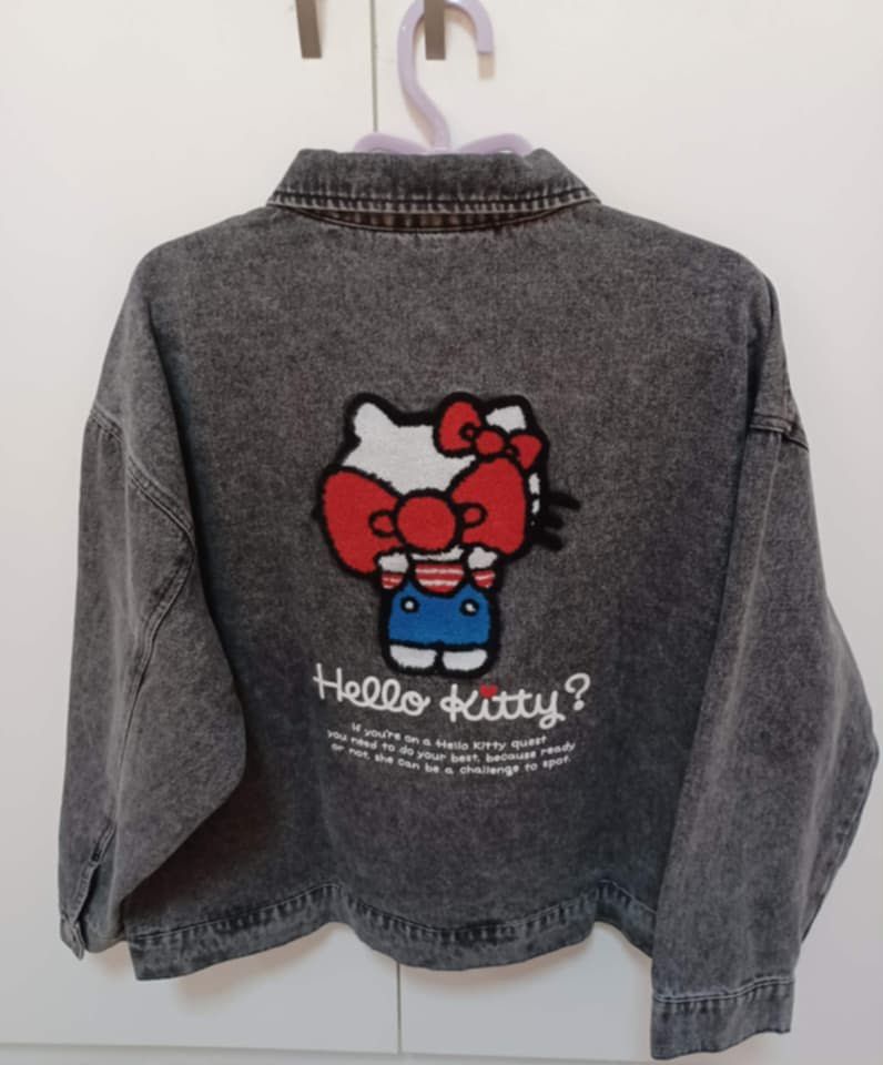 Hello Kitty Denim Jacket (Category: Coats, Jackets and Outerwear) located in San Fernando. Submitted by cjsllmb (Listing ID 1420934476, Image 2). Description: - Gray wash denim jacket - Kitty design on front and back - Two front pockets - Button closures - Relaxed fit - Large Kitty patch on the back with text. HK Denim Jacket 3,500 Size-L on tag (runs big up to XXXL).