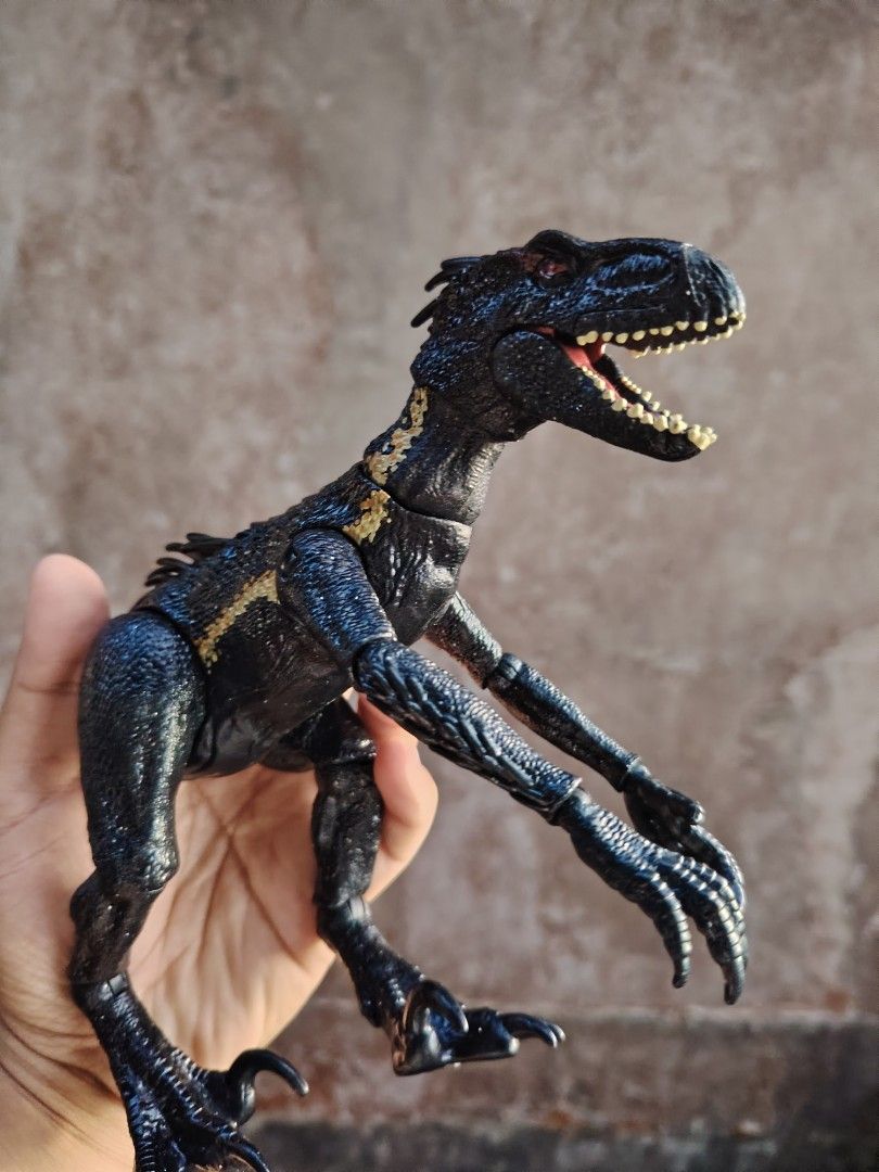 Jurassic World Indoraptor Action Figure (Category: Figurines & Statues) located in Baguio. Submitted by lukewarmwaterboy (Listing ID 1420828596, Image 2). Description: - Jurassic World Indoraptor action figure - Detailed design - Articulated limbs - Black and gold color scheme - Textured skin and sharp claws - Collectible item.