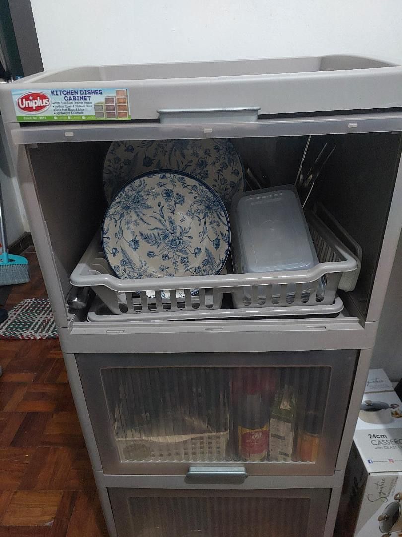 Kitchen Dish Cabinet (Category: Shelves, Cabinets & Racks) located in Mandaluyong City. Submitted by arcticlily (Listing ID 1420826213, Image 2). Description: Kitchen Dish Cabinet (Plates & utensils not included) ✨-With built-in dish rack and drain tray 🗄️ 3 spacious layers (kasya pati kaldero at lutuan) - Bought August 2025, very good condition ‐ No cracks, sturdy, smooth doors - RFS: Moving out - Price: 1200 Dimensions: H: 104 cm L : 45 cm W: 