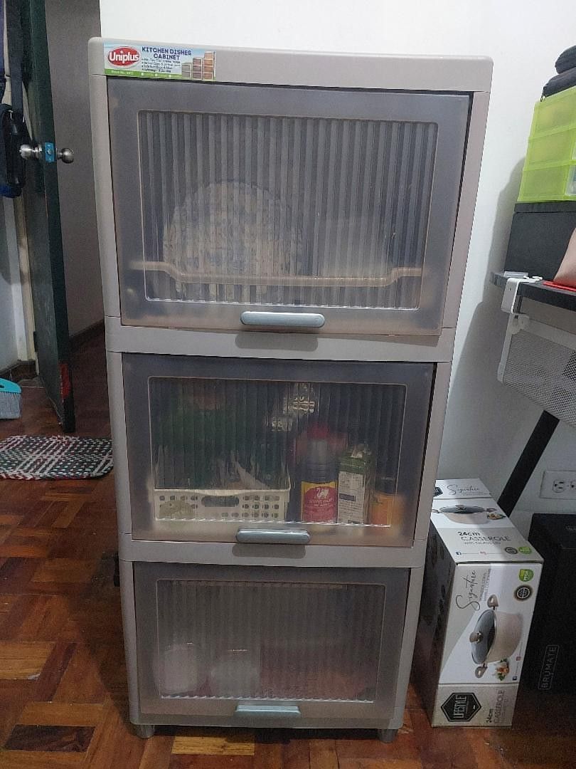 Kitchen Dish Cabinet (Category: Shelves, Cabinets & Racks) located in Mandaluyong City. Submitted by arcticlily (Listing ID 1420826213, Image 3). Description: Kitchen Dish Cabinet (Plates & utensils not included) ✨-With built-in dish rack and drain tray 🗄️ 3 spacious layers (kasya pati kaldero at lutuan) - Bought August 2025, very good condition ‐ No cracks, sturdy, smooth doors - RFS: Moving out - Price: 1200 Dimensions: H: 104 cm L : 45 cm W: 