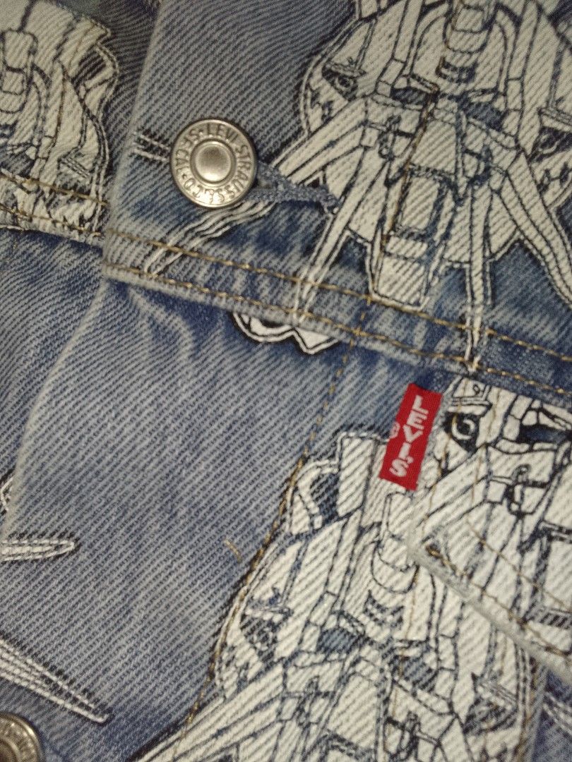 Levi's x Gundam AOP Denim Jacket Large Oversized (Category: Coats, Jackets and Outerwear) located in Zamboanga. Submitted by nurbya898048 (Listing ID 1420825300, Image 3). Description: - Levi's denim jacket - Unique all-over Gundam print - Classic button-up design - Features two chest pockets and two side pockets - Includes Levi's red tab - Light-colored lining - Made in China - Size Large/Oversized - Measurement Width 26 Length 28 Shoulder 21 Sl