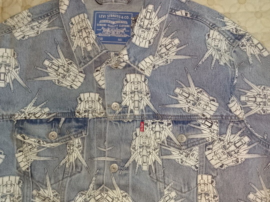 Levi's x Gundam AOP Denim Jacket Large Oversized (Category: Coats, Jackets and Outerwear) located in Zamboanga. Submitted by nurbya898048 (Listing ID 1420825300, Image 2). Description: - Levi's denim jacket - Unique all-over Gundam print - Classic button-up design - Features two chest pockets and two side pockets - Includes Levi's red tab - Light-colored lining - Made in China - Size Large/Oversized - Measurement Width 26 Length 28 Shoulder 21 Sl