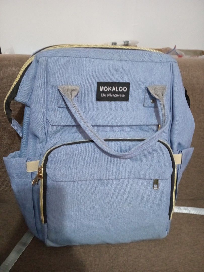 Mokaloo Diaper Bag - Blue (Category: Diaper Bags & Wetbags) located in Marikina City. Submitted by joyful.finds (Listing ID 1420759862, Image 1). Description: - Light blue Mokaloo diaper bag - Multiple compartments for organization - Adjustable straps for comfortable carrying - Front zippered pocket - Side pockets for bottles - Stylish and functional design.