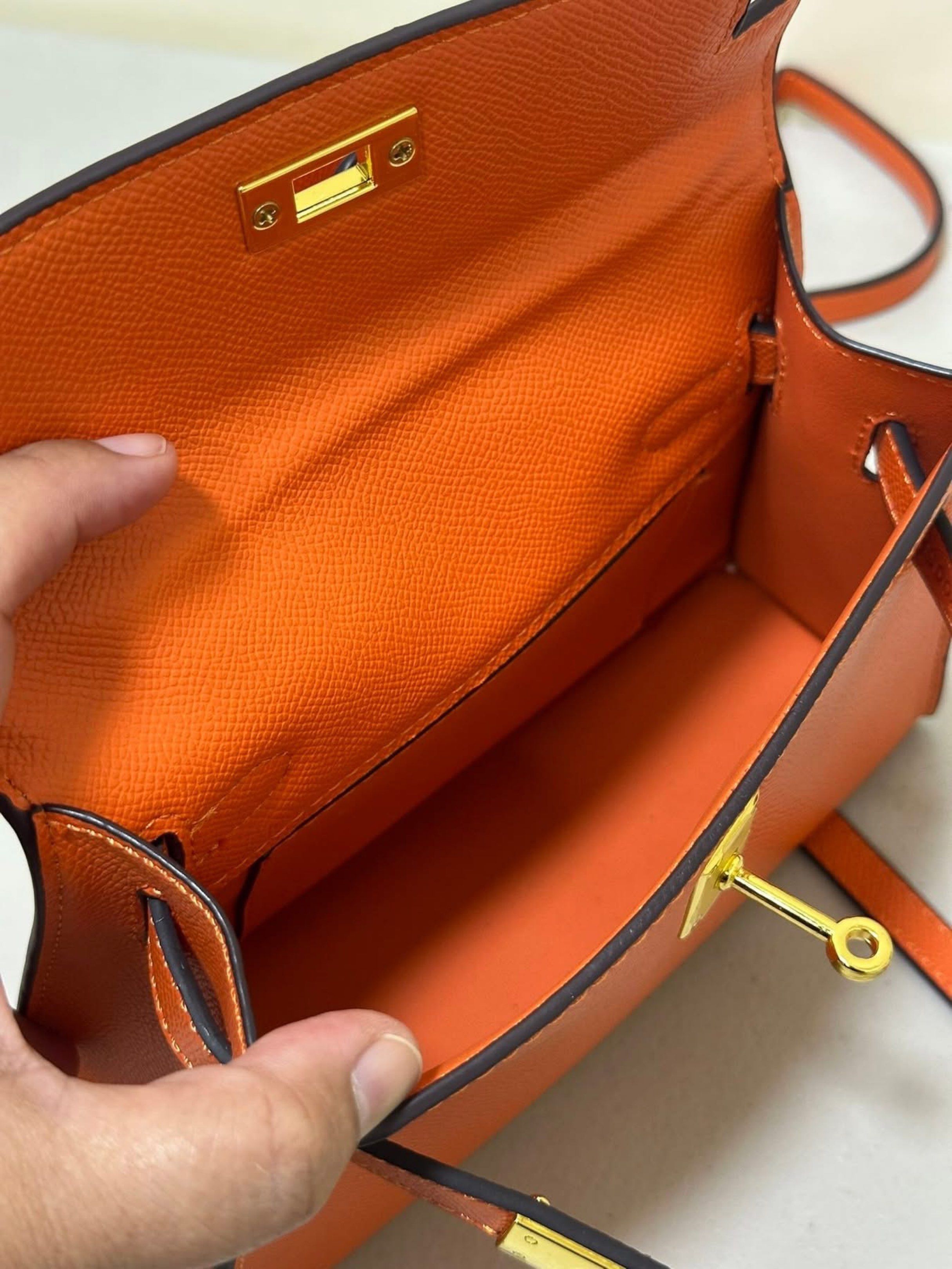 Orange Handbag with Lock and Key (Category: Luxury Bags & Wallets) located in Los Banos. Submitted by ditasbautista2329 (Listing ID 1420933685, Image 3). Description: - Orange handbag - Top handle and detachable shoulder strap - Gold-colored lock with keys - Matching orange interior - Structured design - Gold-toned hardware - Small size, ideal for essentials.