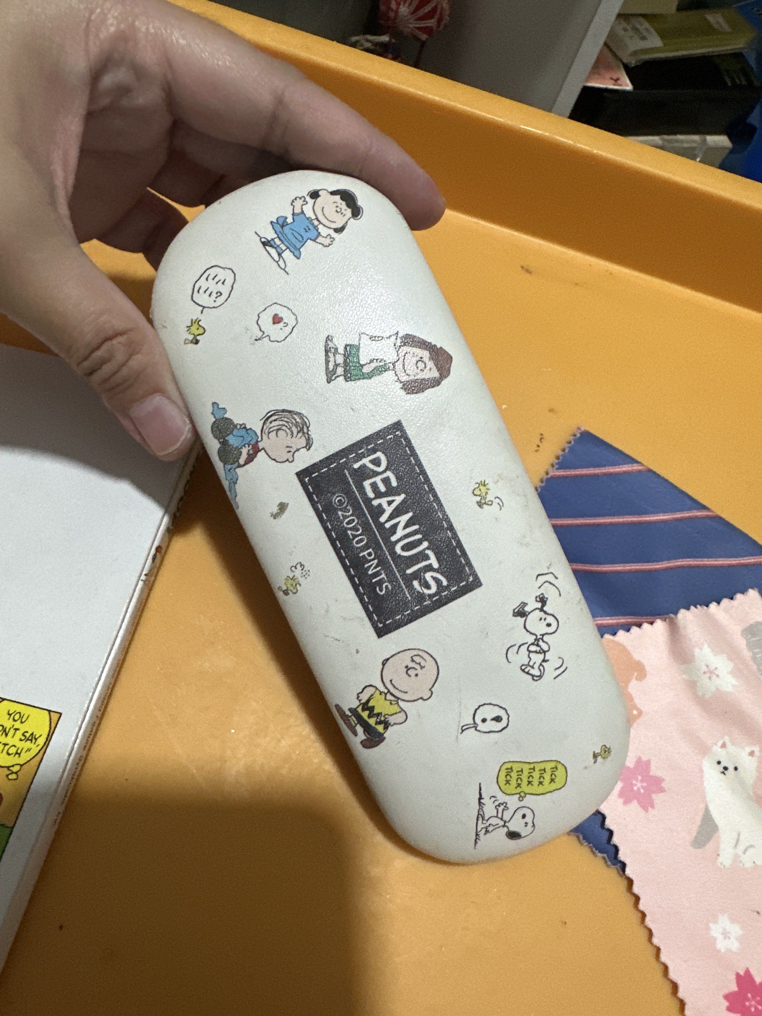Peanuts Snoopy Eyeglass Case (Category: Sunglasses & Eyewear) located in Cainta. Submitted by shopbyyna (Listing ID 1420813391, Image 3). Description: - Snoopy eyeglass case featuring Peanuts characters - Case interior: Light blue - "Snoopy" comic book included - Features Snoopy and Charlie Brown - Comes with two cleaning cloths with assorted patterns.