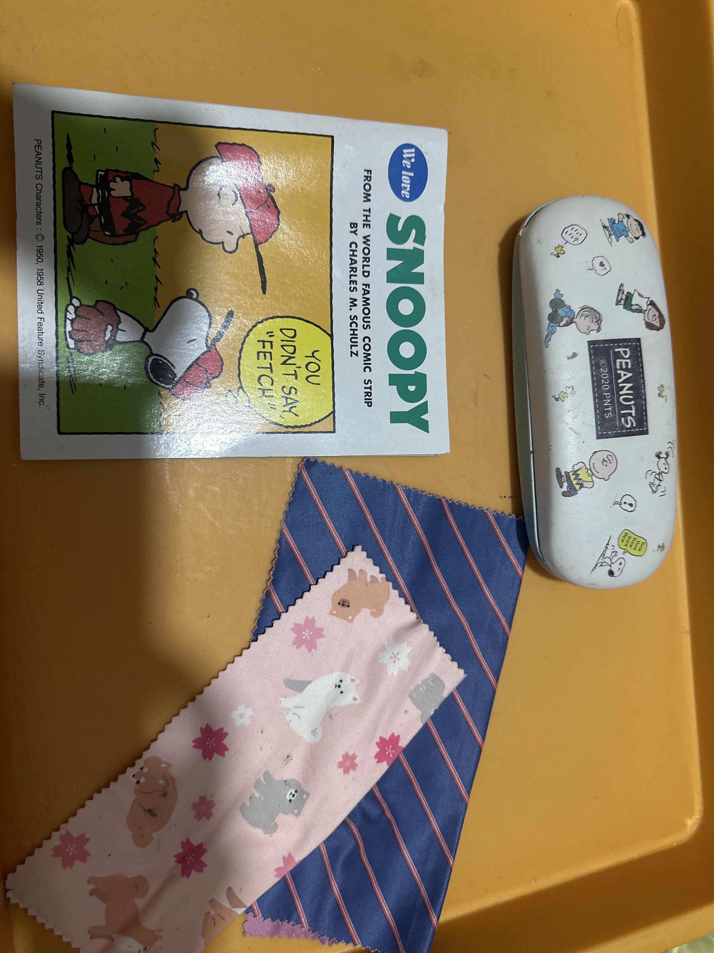 Peanuts Snoopy Eyeglass Case (Category: Sunglasses & Eyewear) located in Cainta. Submitted by shopbyyna (Listing ID 1420813391, Image 1). Description: - Snoopy eyeglass case featuring Peanuts characters - Case interior: Light blue - "Snoopy" comic book included - Features Snoopy and Charlie Brown - Comes with two cleaning cloths with assorted patterns.