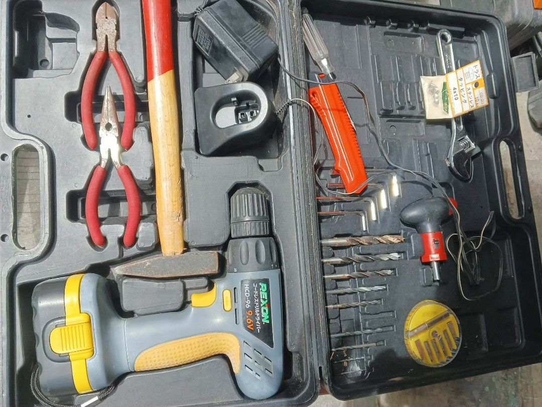 Rexon 9.6V Cordless Drill Tool Kit (Category: Construction Tools & Equipment) located in Caloocan City. Submitted by surplusandbnewshop (Listing ID 1420833395, Image 1). Description: Tool kit includes a Rexon 9.6V cordless drill, various drill bits, pliers, a hammer, and other hand tools. It comes with a charger. The kit is housed in a black carrying case for easy storage and transport. Perfect for home repairs and DIY projects..