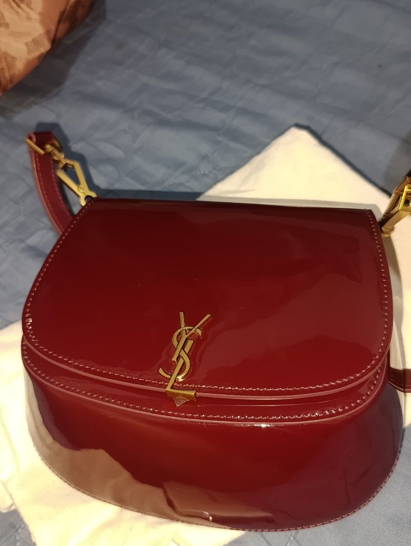 Saint Laurent Le 57 Hobo Bag (Category: Luxury Bags & Wallets) located in Quezon City. Submitted by iamshane2019 (Listing ID 1420863678, Image 2). Description: - Saint Laurent Le 57 Hobo Bag - Rich burgundy patent leather - Gold-tone YSL logo and hardware - Includes dust bag - Interior serial number - Magnetic closure - Adjustable strap - Stylish and versatile japan preloved bag ysl.voltaire slight negotiable.