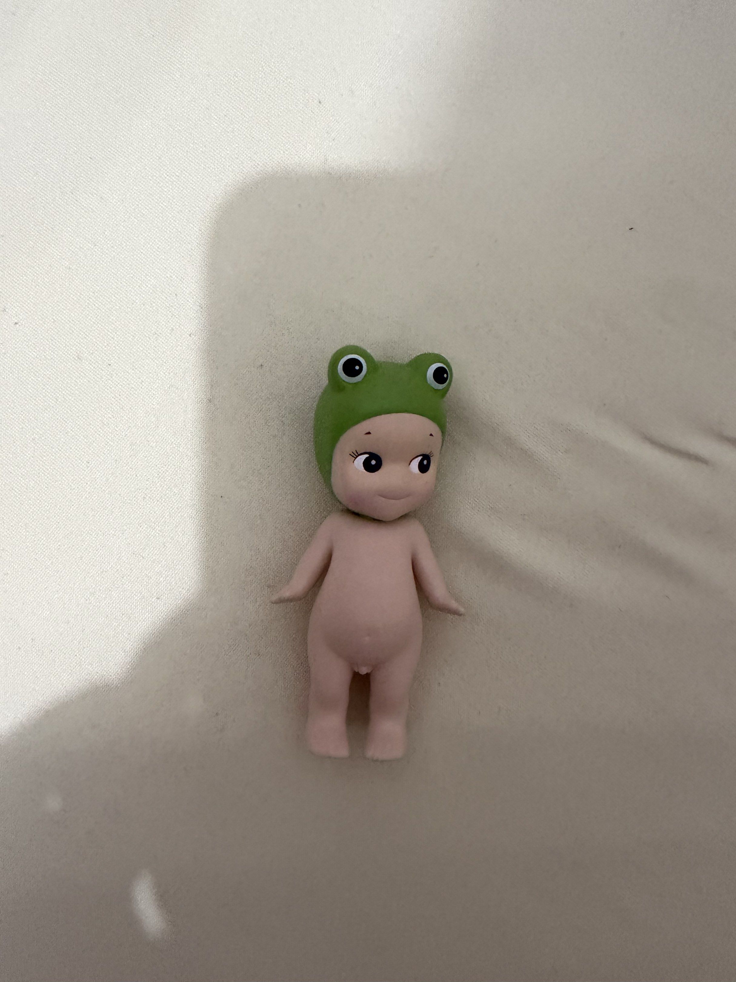 Sonny Angel Frog Figurine (Category: Designer & Blind Box Toys) located in Davao. Submitted by fabdeclutter (Listing ID 1420865581, Image 2). Description: - Adorable Sonny Angel figurine. - Features a charming frog hat. - Light skin tone and standing pose. - Cute, smiling expression. - Collectible item. - Ideal for display or gifting..