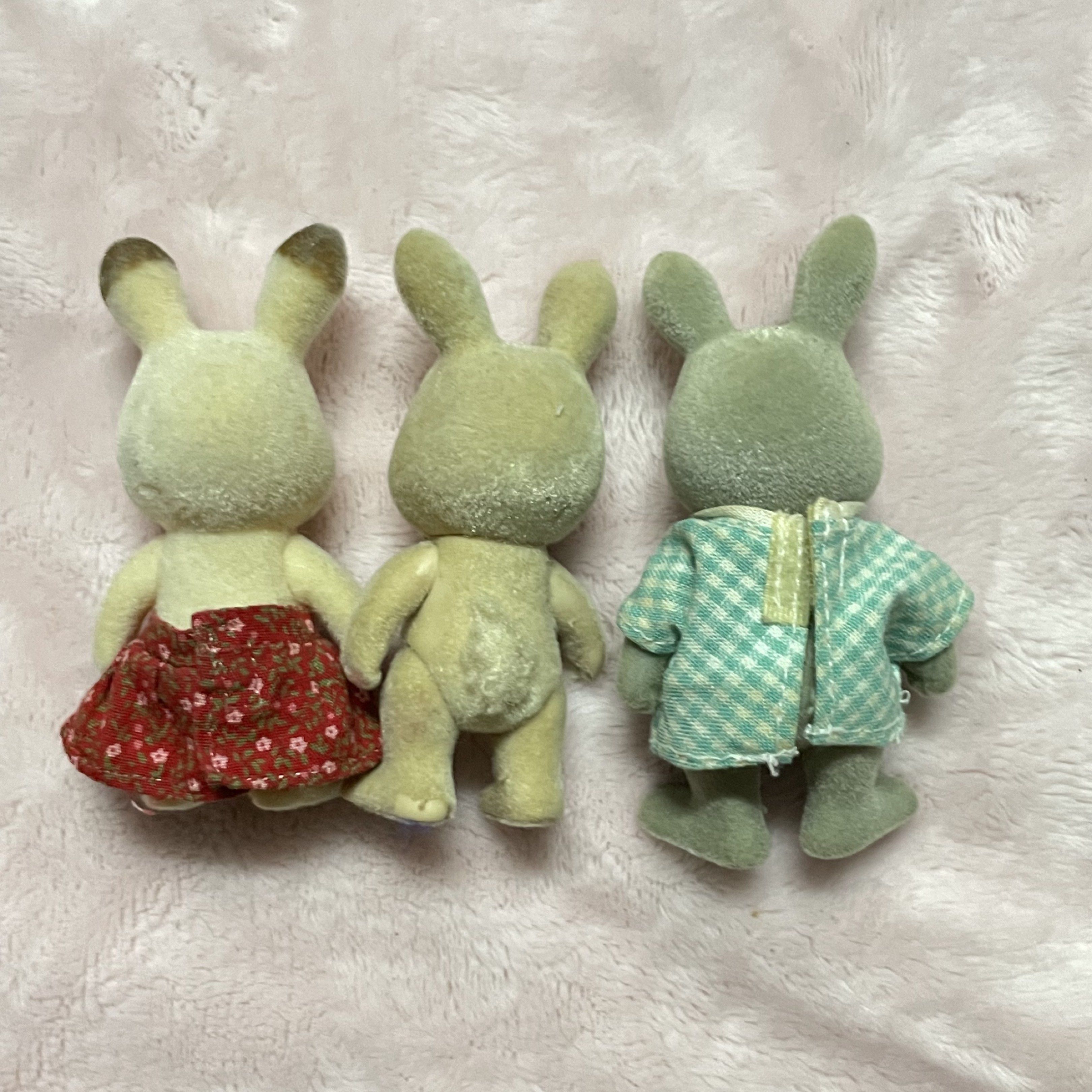 Sylvanian Families Rabbit Figures Set (Category: Figurines & Statues) located in Manila. Submitted by annemargarettes (Listing ID 1420862001, Image 2). Description: - Set of three Sylvanian Families rabbit figures - Includes: - Rabbit with red floral skirt - Rabbit without clothing - Rabbit with green checkered shirt - Standing pose - Flocked surfaces - Detailed features.