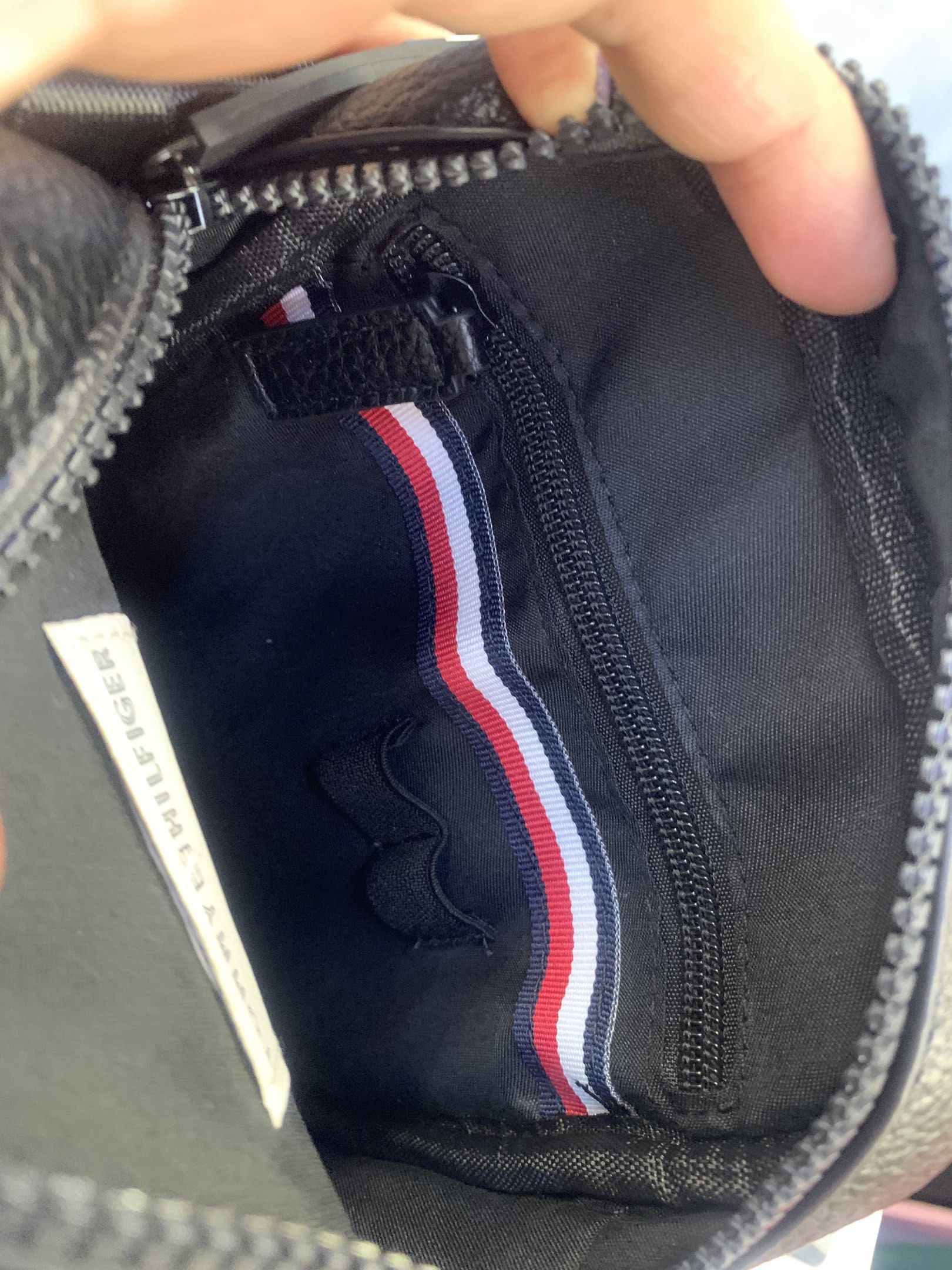 Tommy Hilfiger Black Crossbody Bag (Category: Cross-body Bags) located in Quezon City. Submitted by applelux (Listing ID 1420798934, Image 3). Description: - Black Tommy Hilfiger crossbody bag - Main compartment with zipper closure - Additional front pocket - Detachable and adjustable shoulder strap - Tommy Hilfiger logo on the front - Small logo detail on zipper pull - Interior zippered pocket.