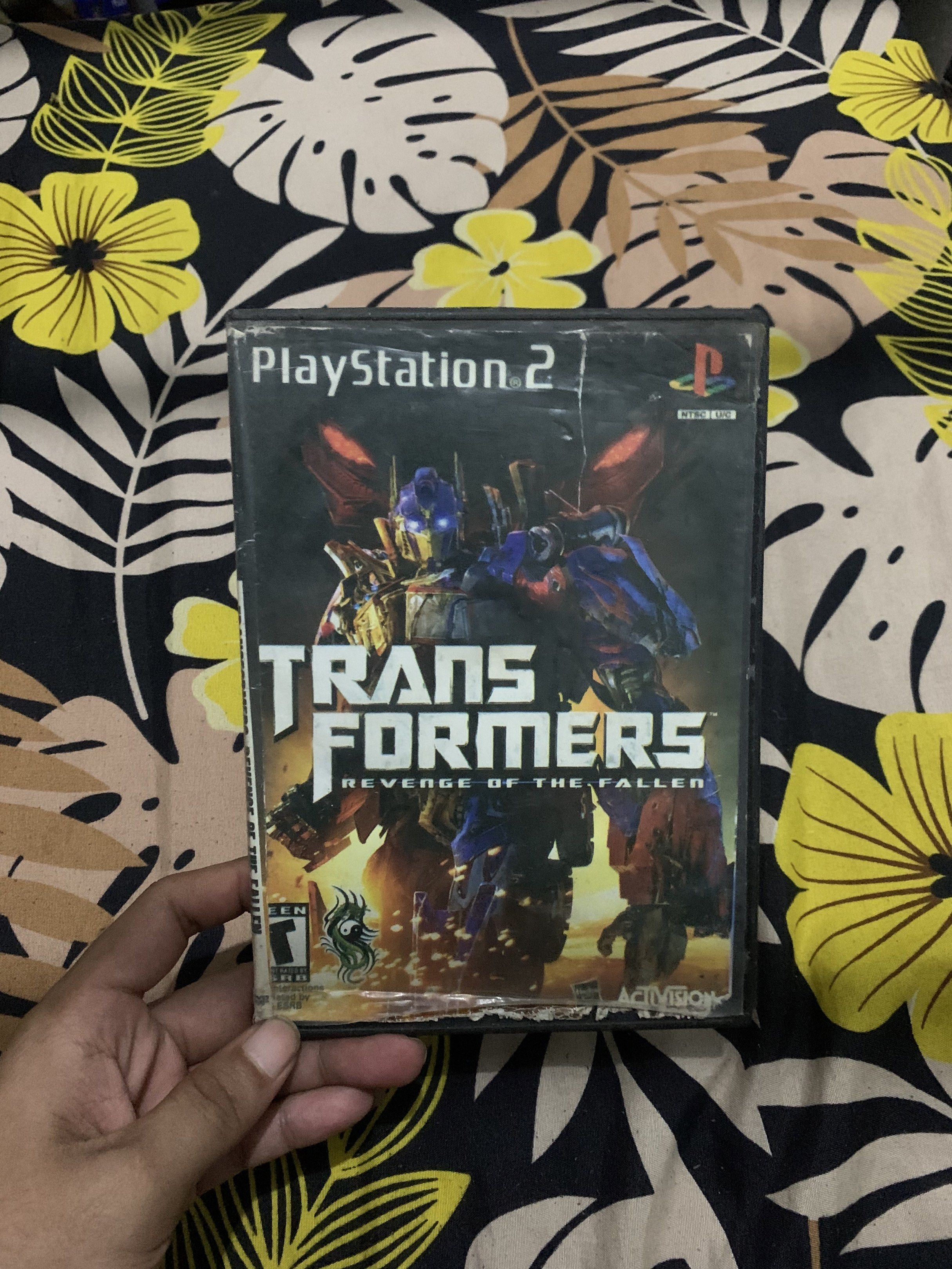 Transformers: Revenge of the Fallen - PS2 (Category: PlayStation) located in Manila. Submitted by declutteringog7 (Listing ID 1420843310, Image 1). Description: - Transformers: Revenge of the Fallen for PlayStation 2 - Includes game disc and case - Rated T for Teen - Case has some wear and tear - DVD game.