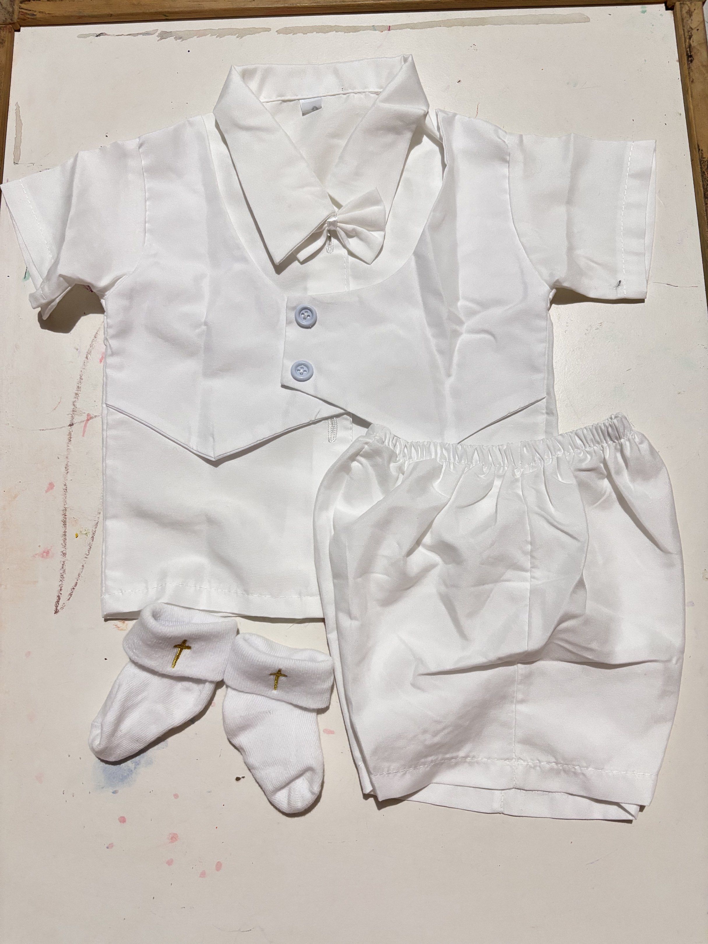 White Baptismal Outfit Set (Category: Babies & Kids Fashion) located in Concepcion. Submitted by cherishedthreads (Listing ID 1420885294, Image 1). Description: - Complete baptismal outfit set for baby - Includes: - Short-sleeved shirt with vest - Shorts - Bow tie - Socks with gold cross design - Features light blue buttons - Perfect for baptism or other special occasions.