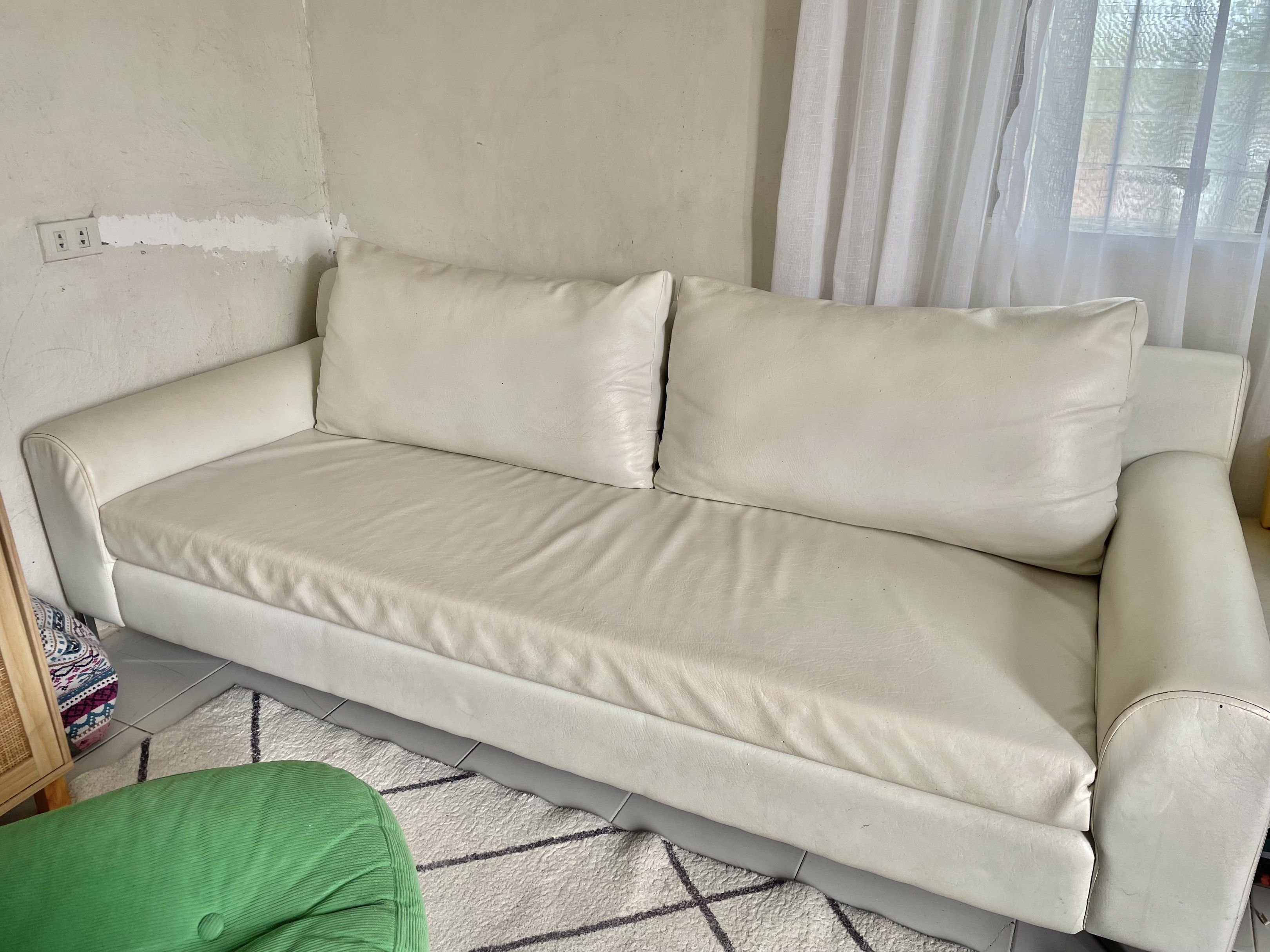 3-Seater White Beige German Leather Sofa (Category: Sofas) located in Santa Rosa. Submitted by basconclarissa (Listing ID 1420766850, Image 1). Description: - White german leather sectional sofa - Includes a matching square ottoman - Features two back cushions and rounded armrests - Supported by metal legs - Shows some stains and wear, as expected with use - Needs cleaning ** Last 2 photos was 2 years ago when it was newly upholstered. .