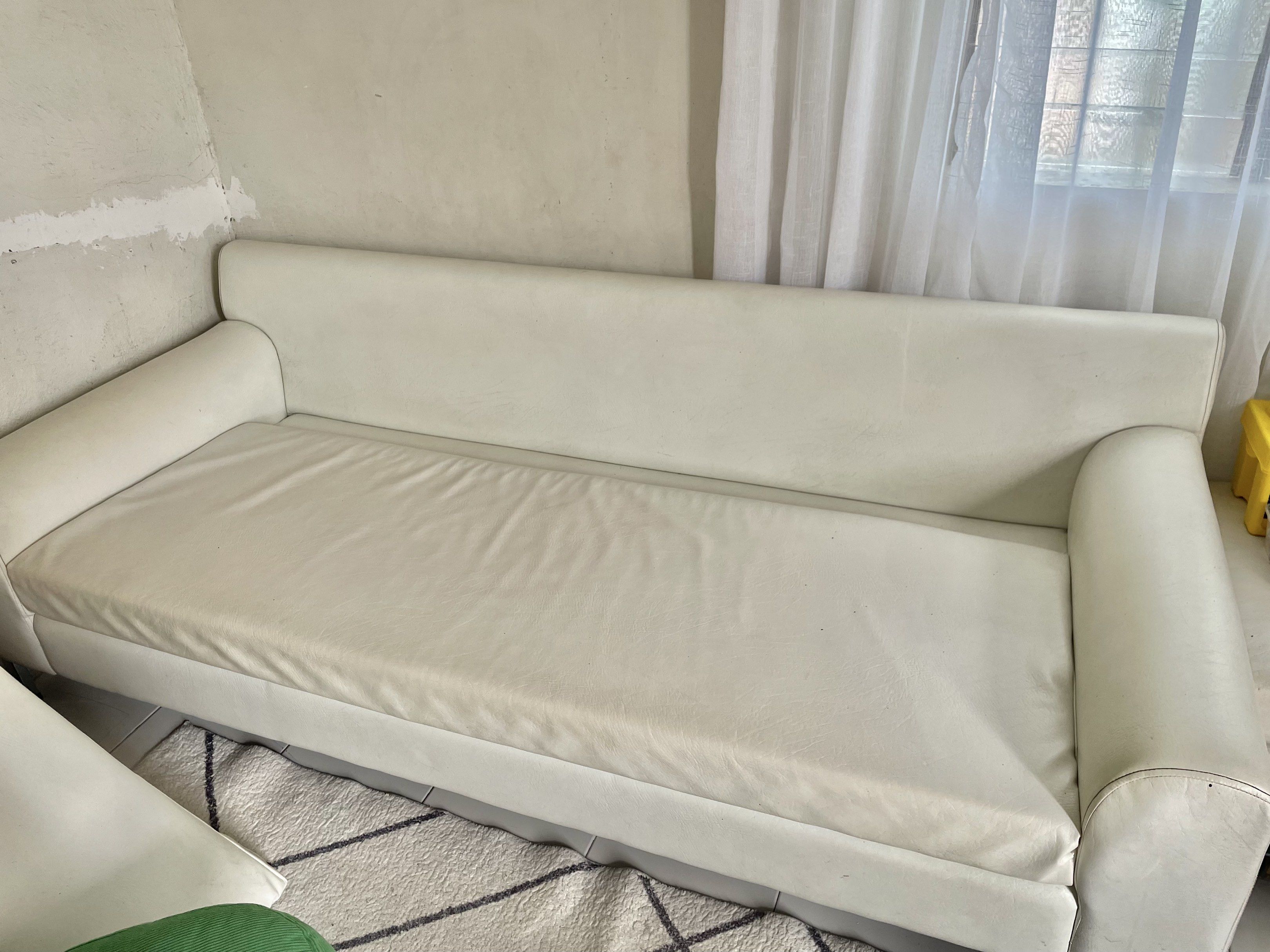 3-Seater White Beige German Leather Sofa (Category: Sofas) located in Santa Rosa. Submitted by basconclarissa (Listing ID 1420766850, Image 2). Description: - White german leather sectional sofa - Includes a matching square ottoman - Features two back cushions and rounded armrests - Supported by metal legs - Shows some stains and wear, as expected with use - Needs cleaning ** Last 2 photos was 2 years ago when it was newly upholstered. .