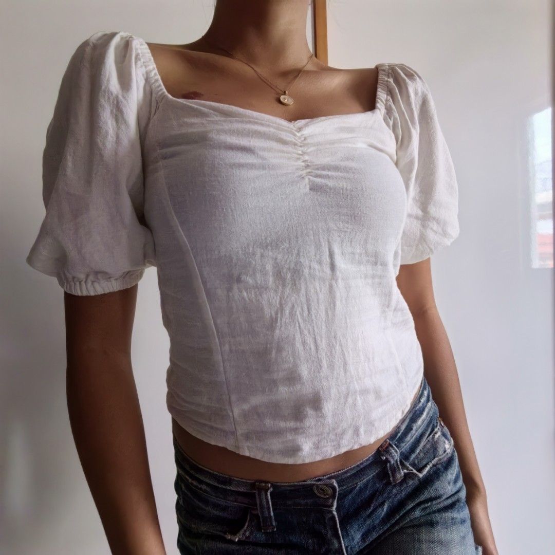 White Puff Sleeve Square Neckline Ruched Front Linen Top (Category: Blouses) located in Santa Rosa. Submitted by blancrealm (Listing ID 1420849238, Image 1). Description: Model measurements: - Height: 160cm - Shoulders: 42cm - Waist: 27" - Hips: 35" - I feel like this would best fit XS-S - White top with square neckline, puff sleeves, and ruched bust. Fitted silhouette. Lightweight fabric. Great for casual or semi-formal wear..