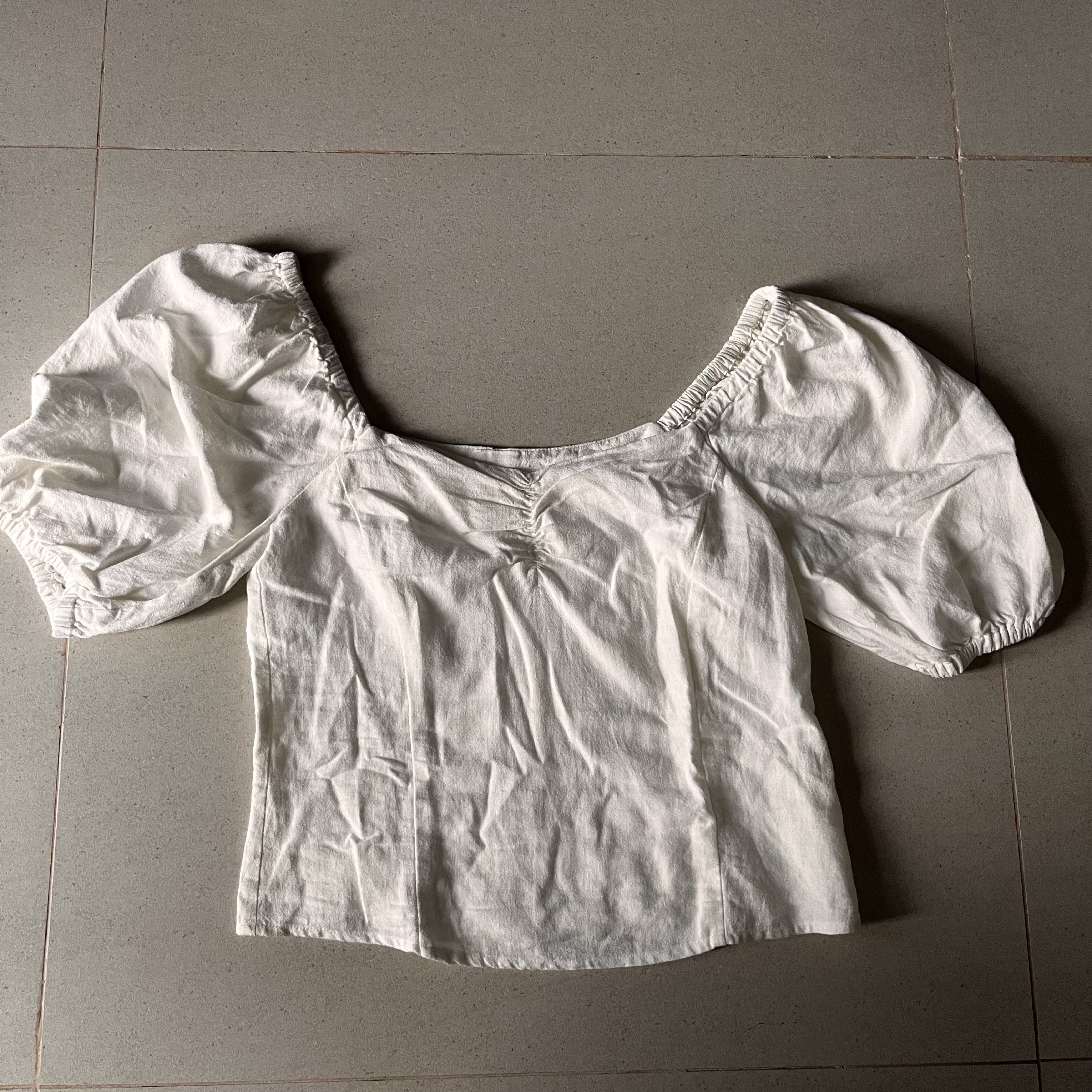 White Puff Sleeve Square Neckline Ruched Front Linen Top (Category: Blouses) located in Santa Rosa. Submitted by blancrealm (Listing ID 1420849238, Image 2). Description: Model measurements: - Height: 160cm - Shoulders: 42cm - Waist: 27" - Hips: 35" - I feel like this would best fit XS-S - White top with square neckline, puff sleeves, and ruched bust. Fitted silhouette. Lightweight fabric. Great for casual or semi-formal wear..