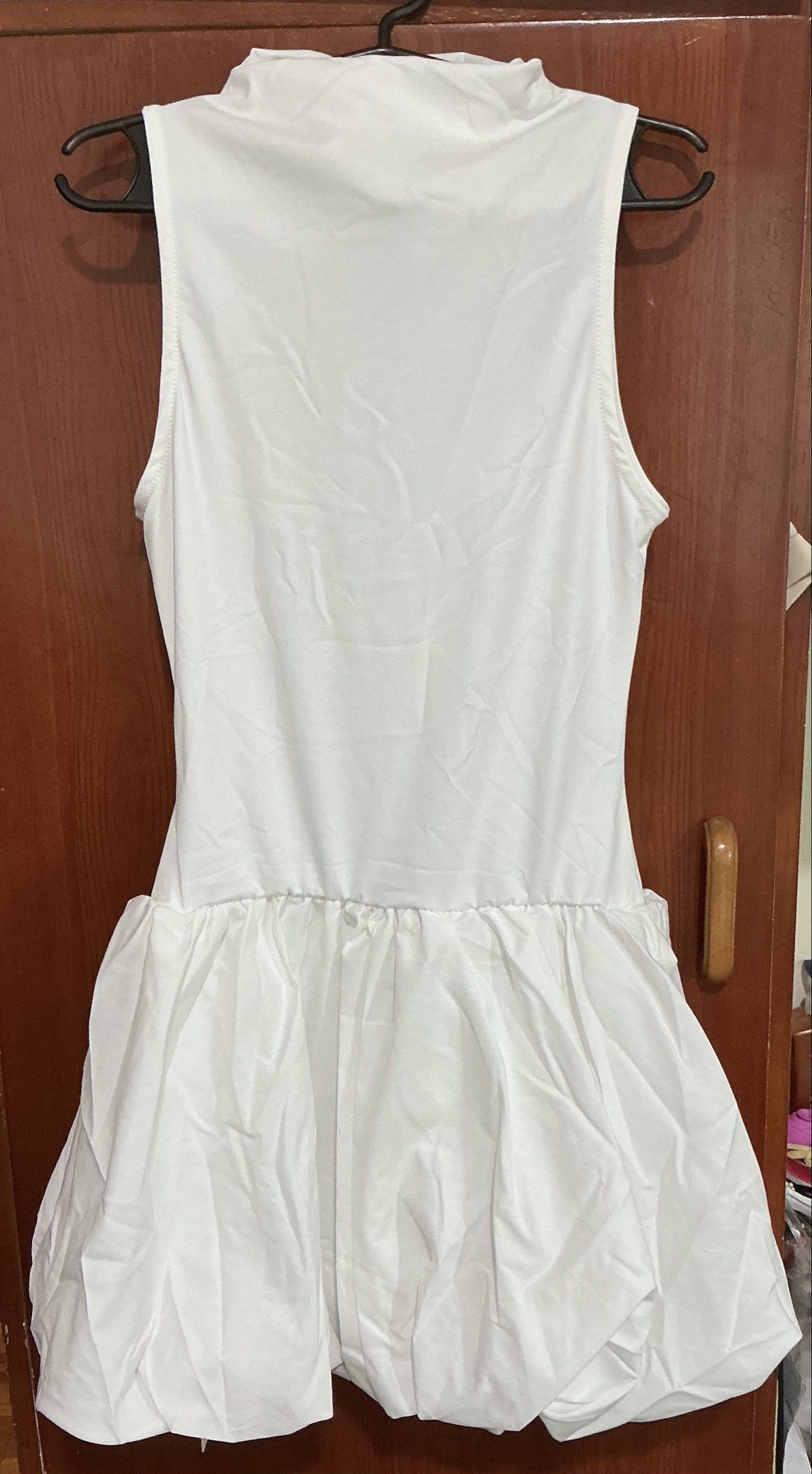XS White Bubble Sleeveless Dress (Category: Dresses) located in Caloocan City. Submitted by ibado (Listing ID 1420783753, Image 2). Description: - SHEINBAE white sleeveless dress - Size: XS - Features a high neckline - Design: Gathered, bubble-style skirt - Condition: New with tag - Fabric: Smooth, likely synthetic - Ideal for parties and special occasions.