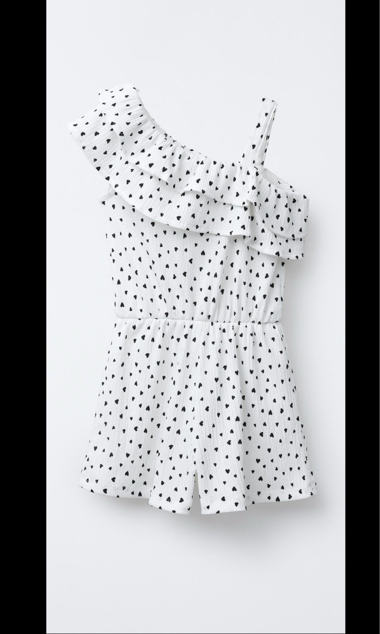 Zara Kids 164cm One Shoulder Romper (Category: Rompers) located in San Pedro. Submitted by abby2194 (Listing ID 1420880235, Image 1). Description: - Size: 13/14 years / 164cm - Adorable white romper with heart print. - Stylish one-shoulder design. - Features a ruffled neckline. - Comfortable elastic waist. - Ideal for warm weather and casual wear. - Made of textured fabric. - Playful and feminine look..