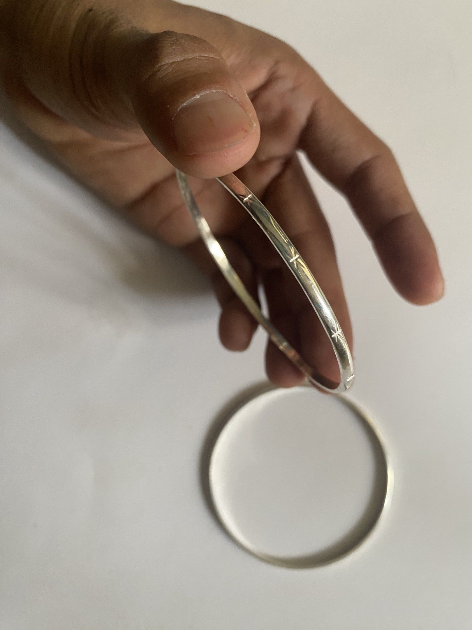 925 Silver Bangles (Category: Bracelets) located in Malolos. Submitted by jjantiques (Listing ID 1421019253, Image 2). Description: For Sale!! 92.5 Silver Bangle with 925 Markings (tested) plain details 8.7 grams 6.35 cm size Price: 1500 pesos each add shipping fee ( Lbc - Set of two silver bangles - One bangle features etched lines and star-like details - The other bangle is plain - Both bangles have a smooth, polished finish - One bangle is mar
