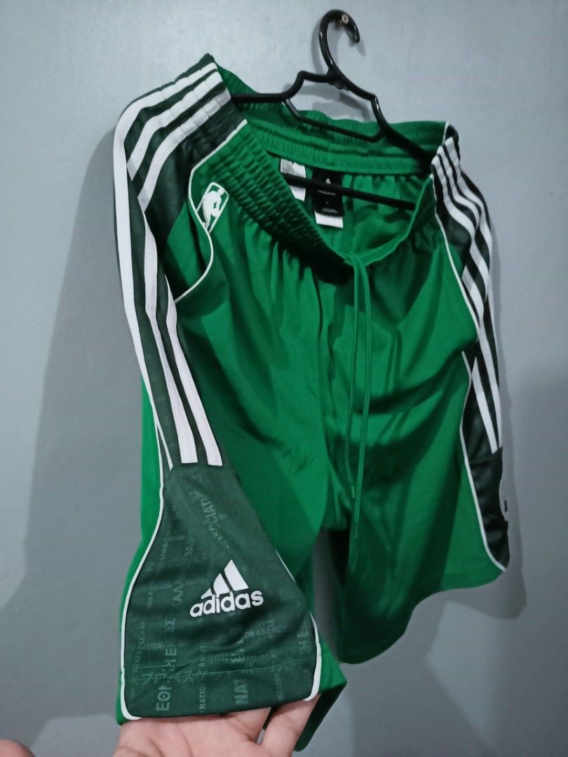 Adidas NBA Boston Celtics Shorts (Category: Shorts) located in Rosales. Submitted by brandeduseditems (Listing ID 1421044151, Image 2). Description: - Green Adidas shorts - Boston Celtics logo - White stripes on sides - Adidas logo on left leg - Drawstring waistband - NBA logo visible - Shiny, athletic material - Genuine 100% In good condition..