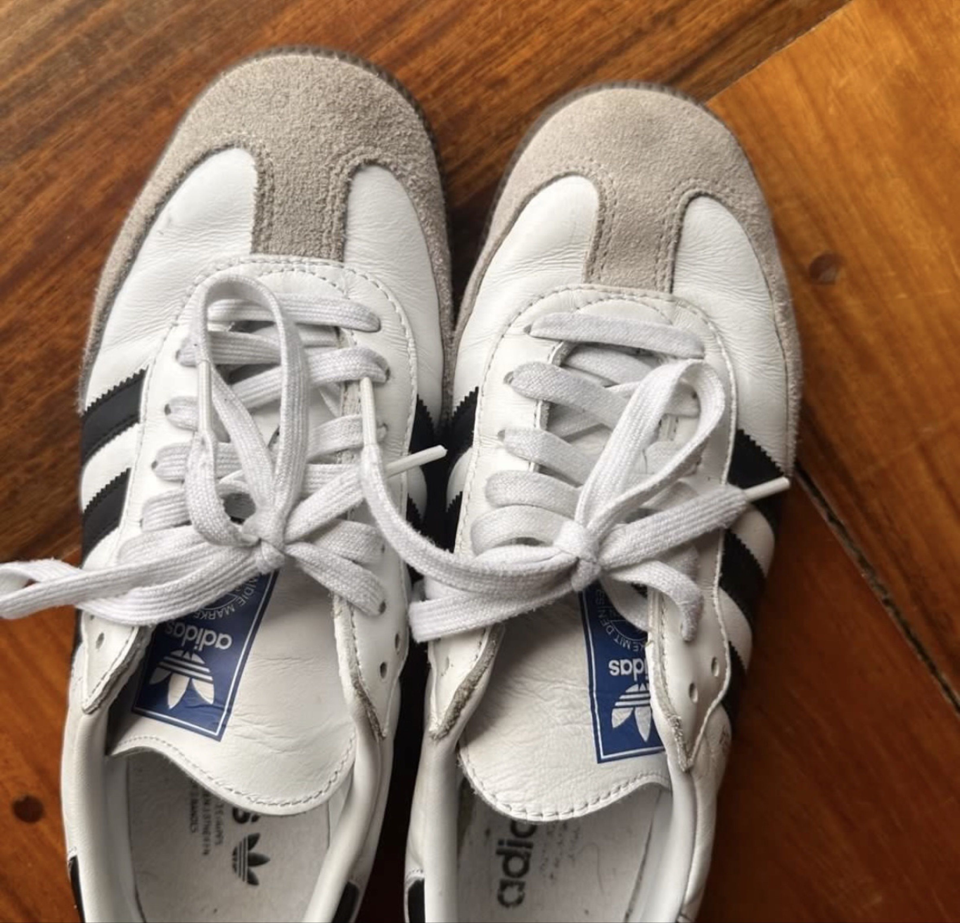 Adidas Samba White Black Sneakers (Category: Sneakers) located in Tarlac. Submitted by airam__ (Listing ID 1421093996, Image 2). Description: - Adidas Samba sneakers - White leather upper with black stripes - Grey suede toe cap - Brown sole - Size: UK 7, US 7.5, FR 40, JP 255, CHN 245 - Made in Vietnam - Features Adidas logo on tongue and insole - White laces - women’s size 8 / men’s size 7.